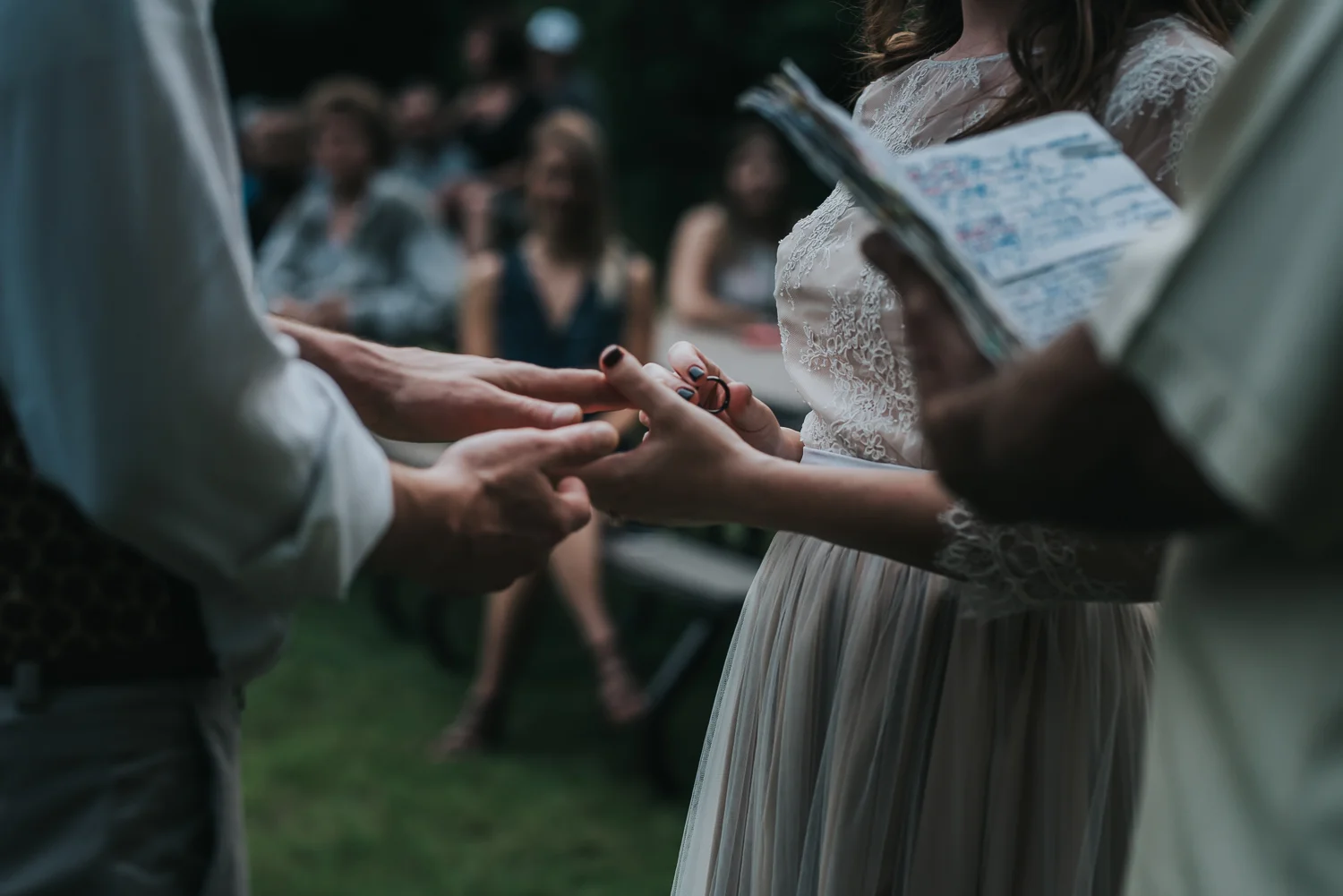 Bride placing the ring on her husband's finger