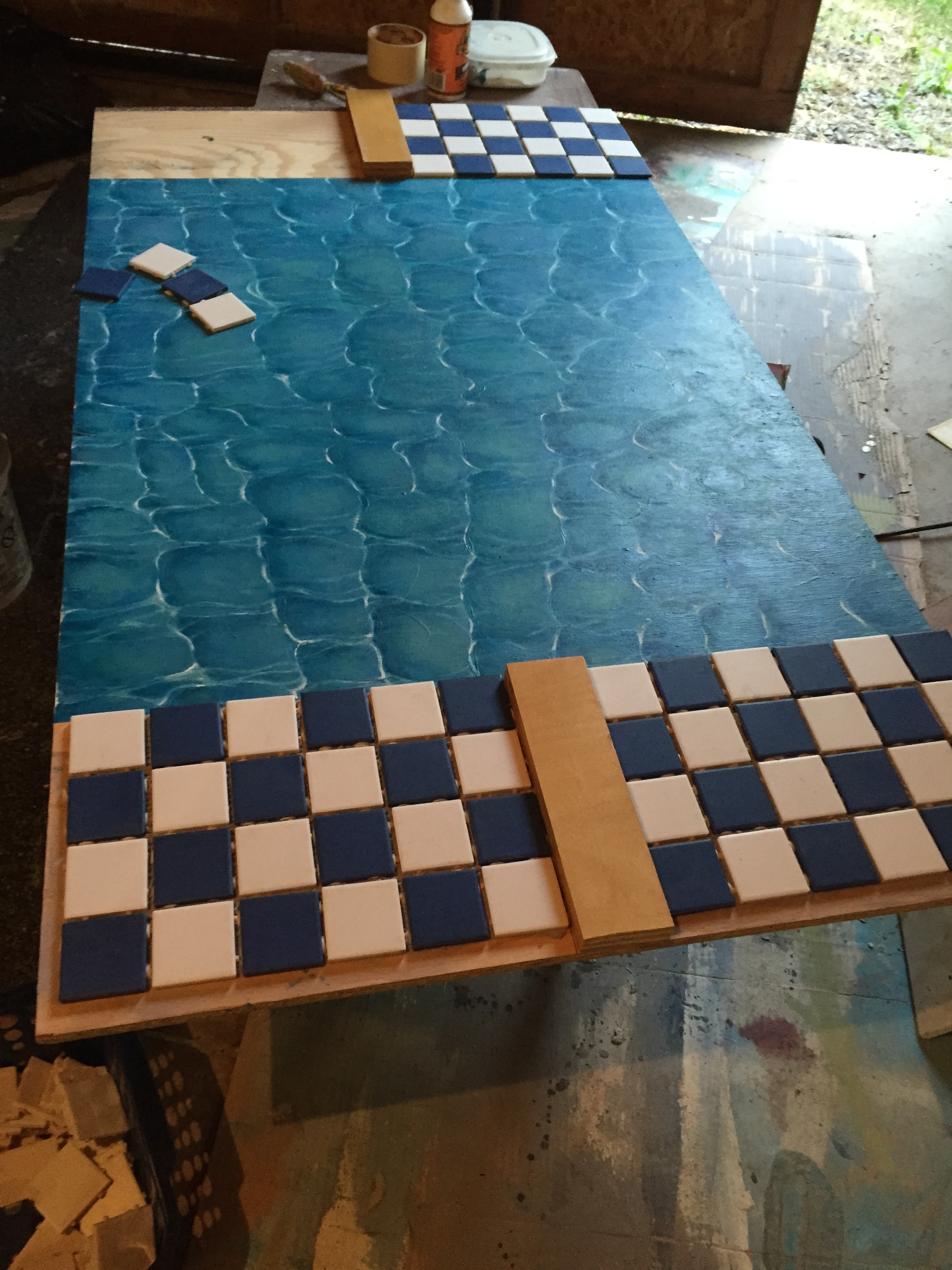 Getting the swimming pool tiles arranged.