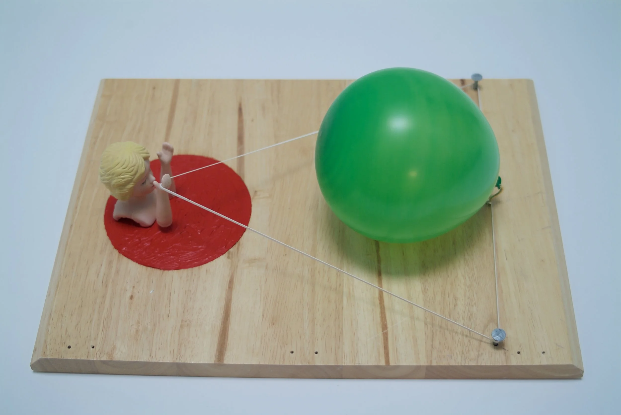 This top down view shows the design to essentially be paired down to three circles; yellow, green and red. Much like the polka dots on a clown or rings, tokens, or buttons on a toy or game.