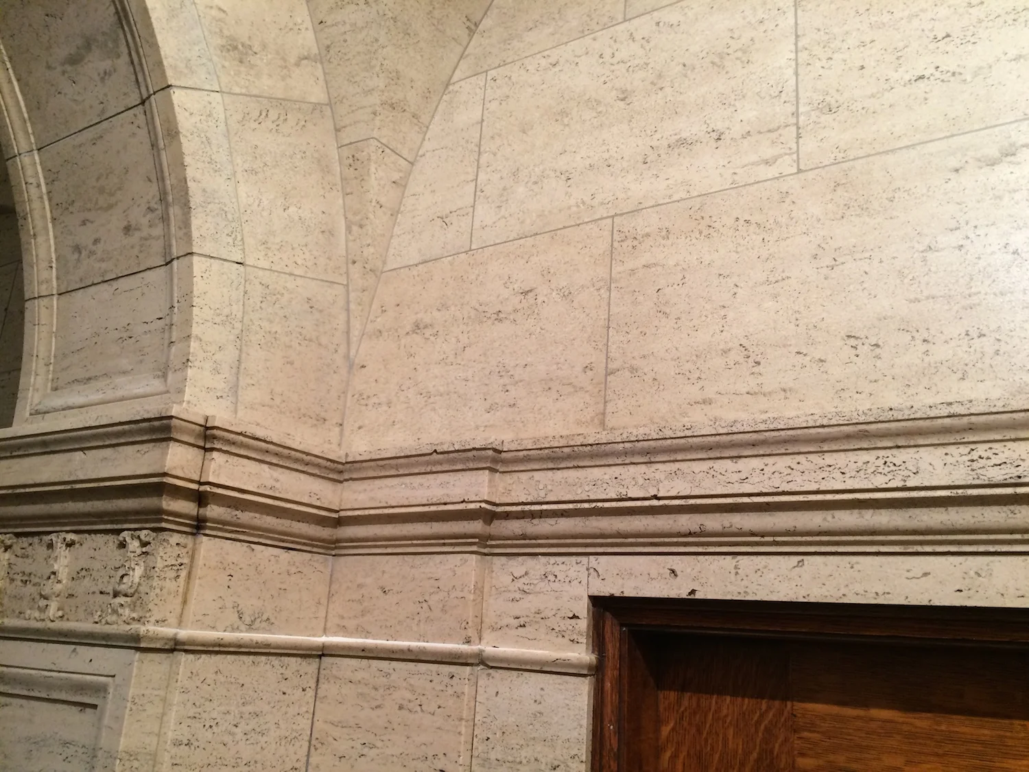   UPPER WALL SECTION PAINTED IN FAUX TRAVERTINE TO MATCH REAL TRAVERTINE BELOW CROWN MOLDING  