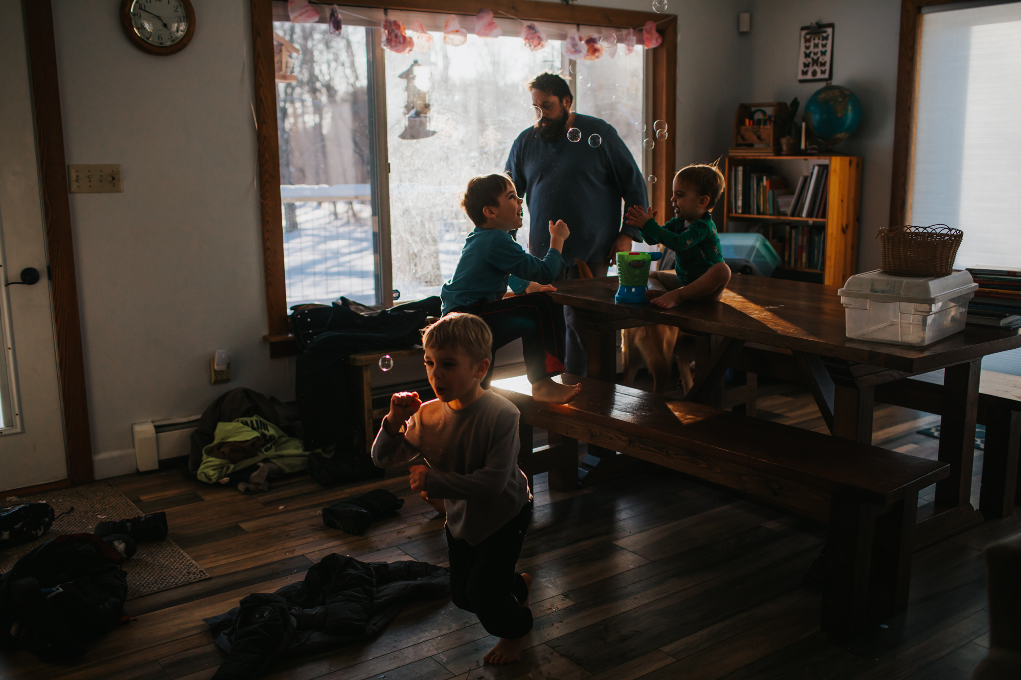 young children playing in a sun filled dining room