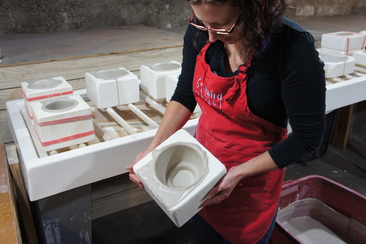 Swirling the clay in the bottom of the mold