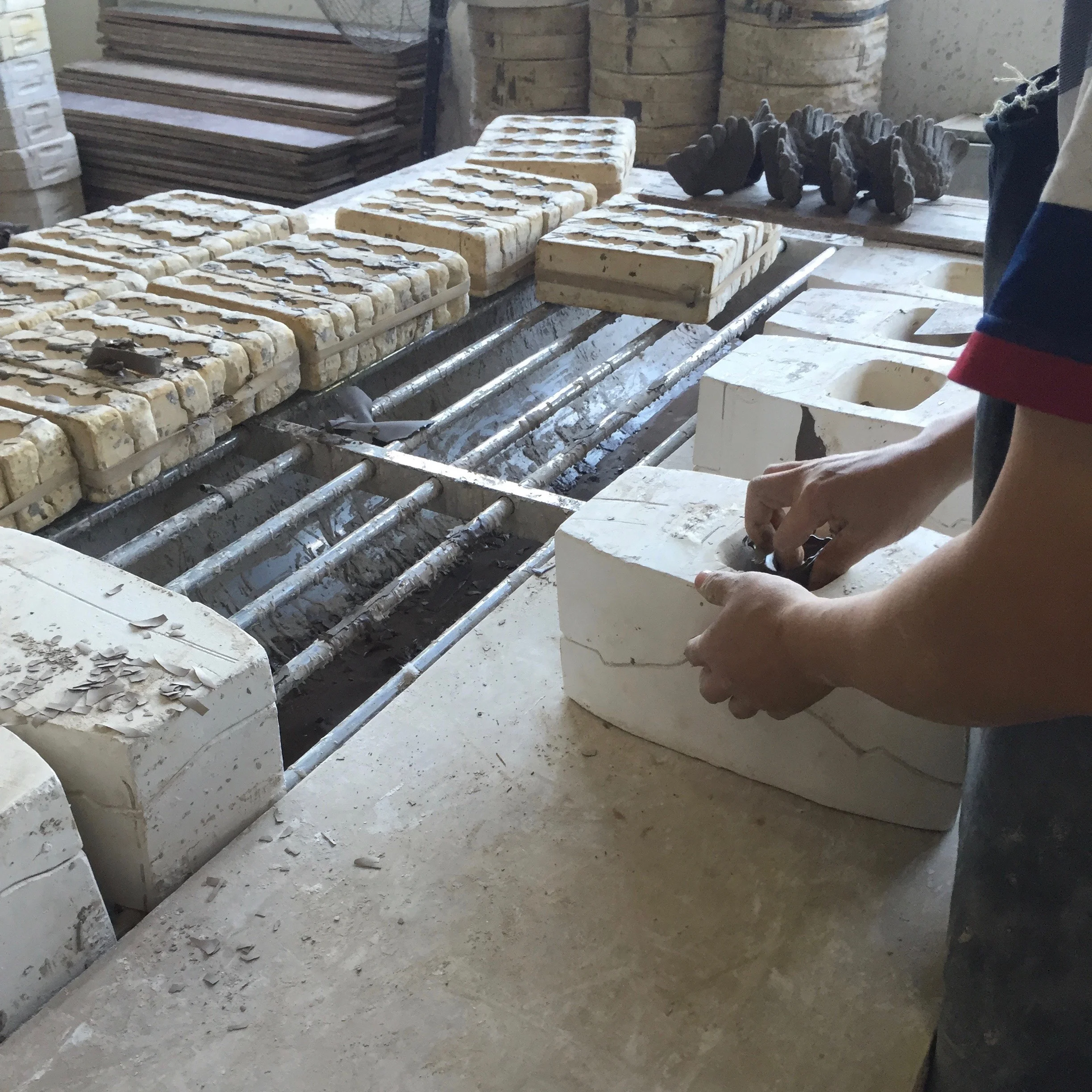 A worker removing the casts from the molds. 