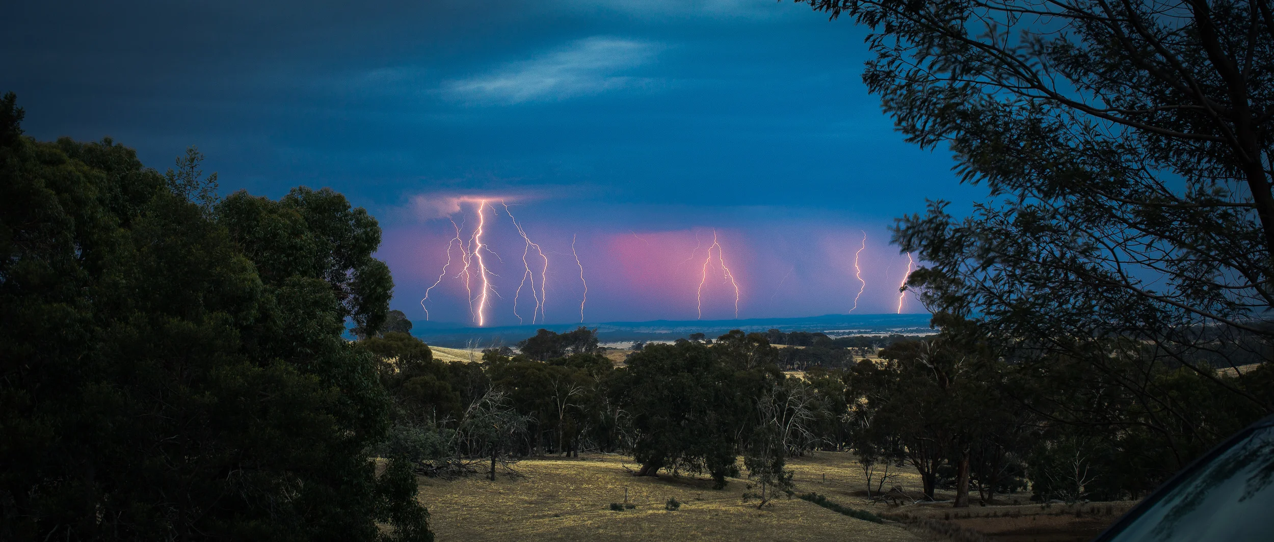The storm as it broke on the last night of filming, the sunset behind casting the clouds pink.