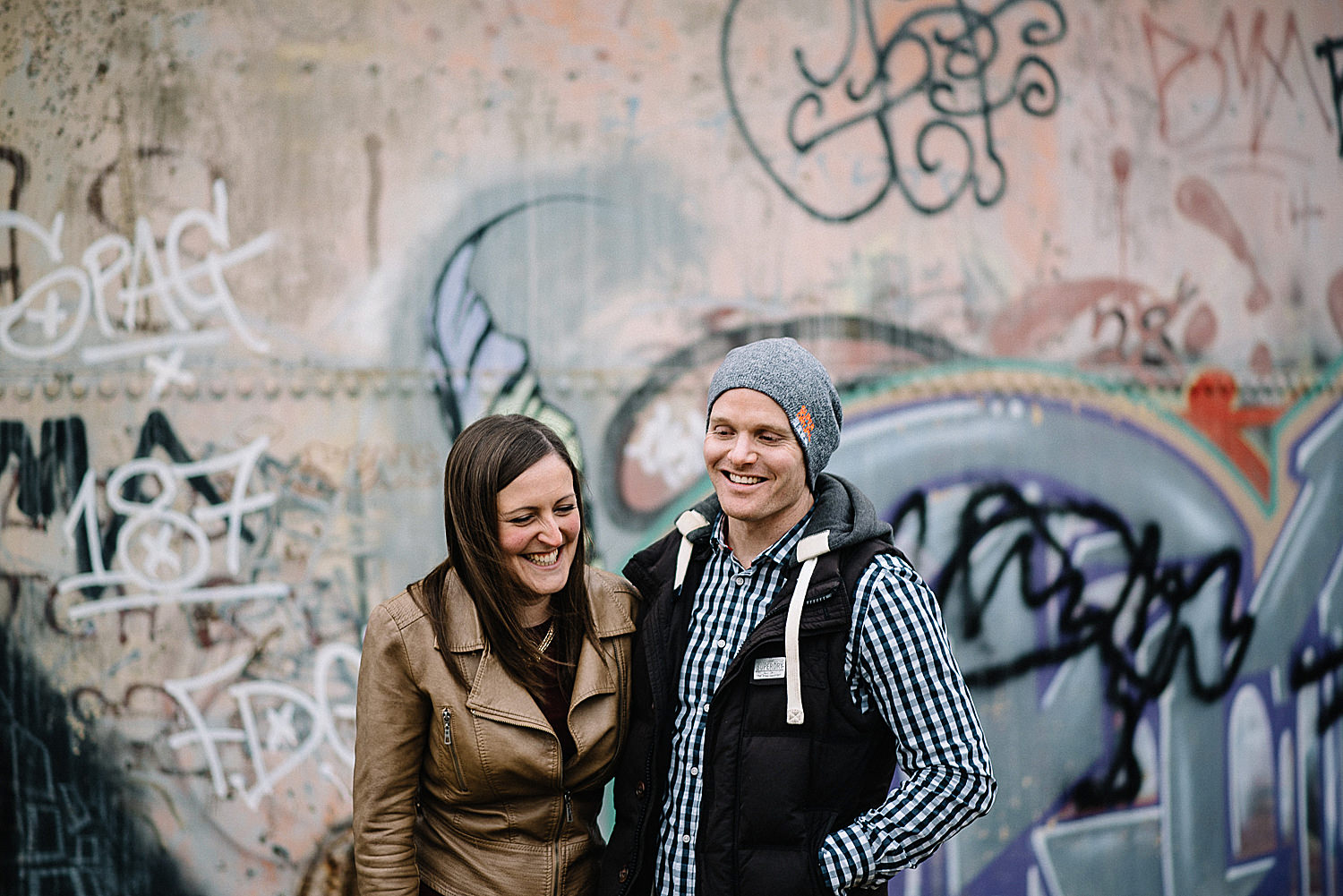engagement shoot in front of graffiti