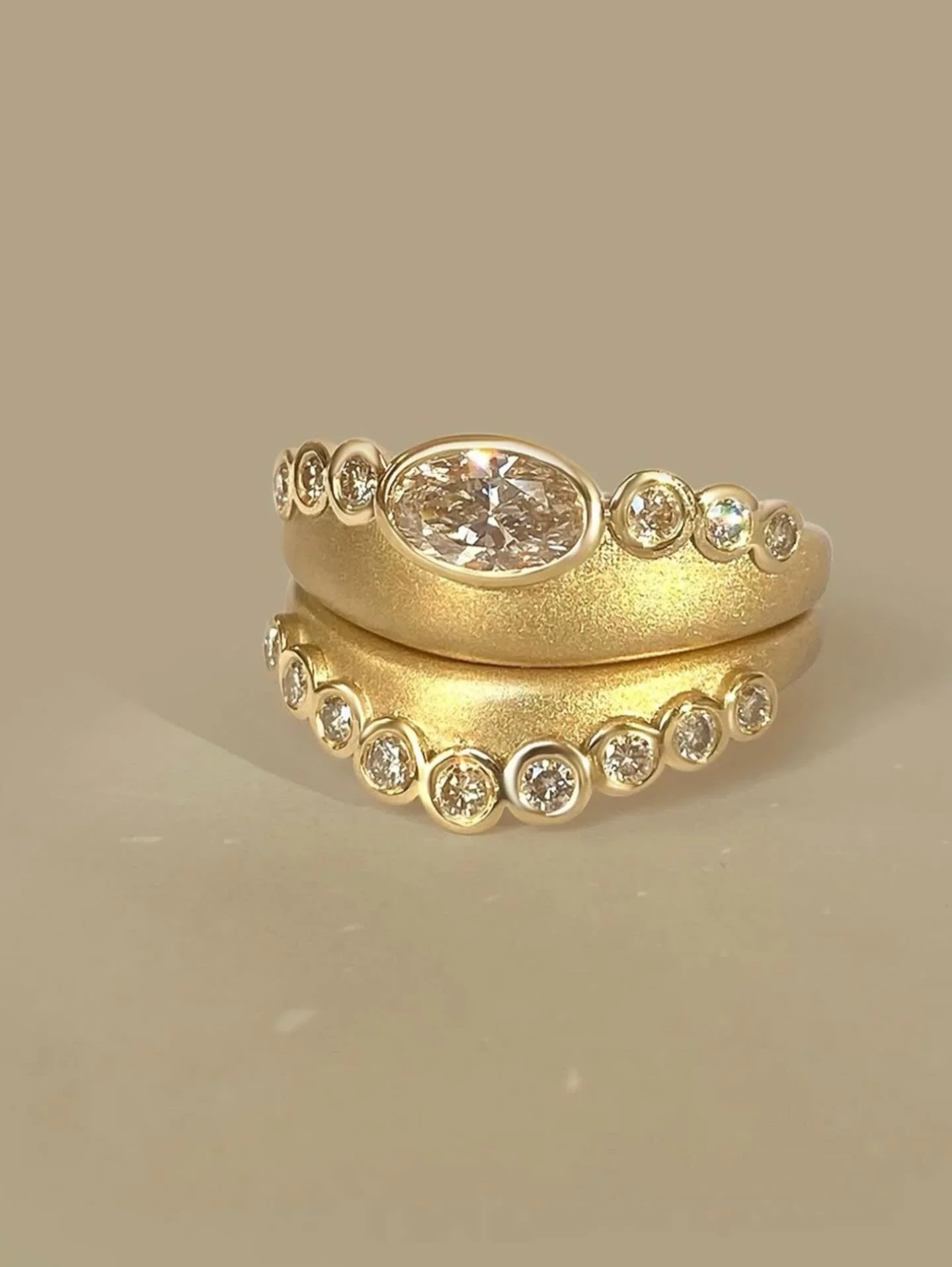 Named after water nymphs in classical mythology, The Naiad Ring and Band reference the rhythmic rise and fall of waves. Worn together, they flirt and fold into one another, echoing the soft, undulating curves of clam shells.