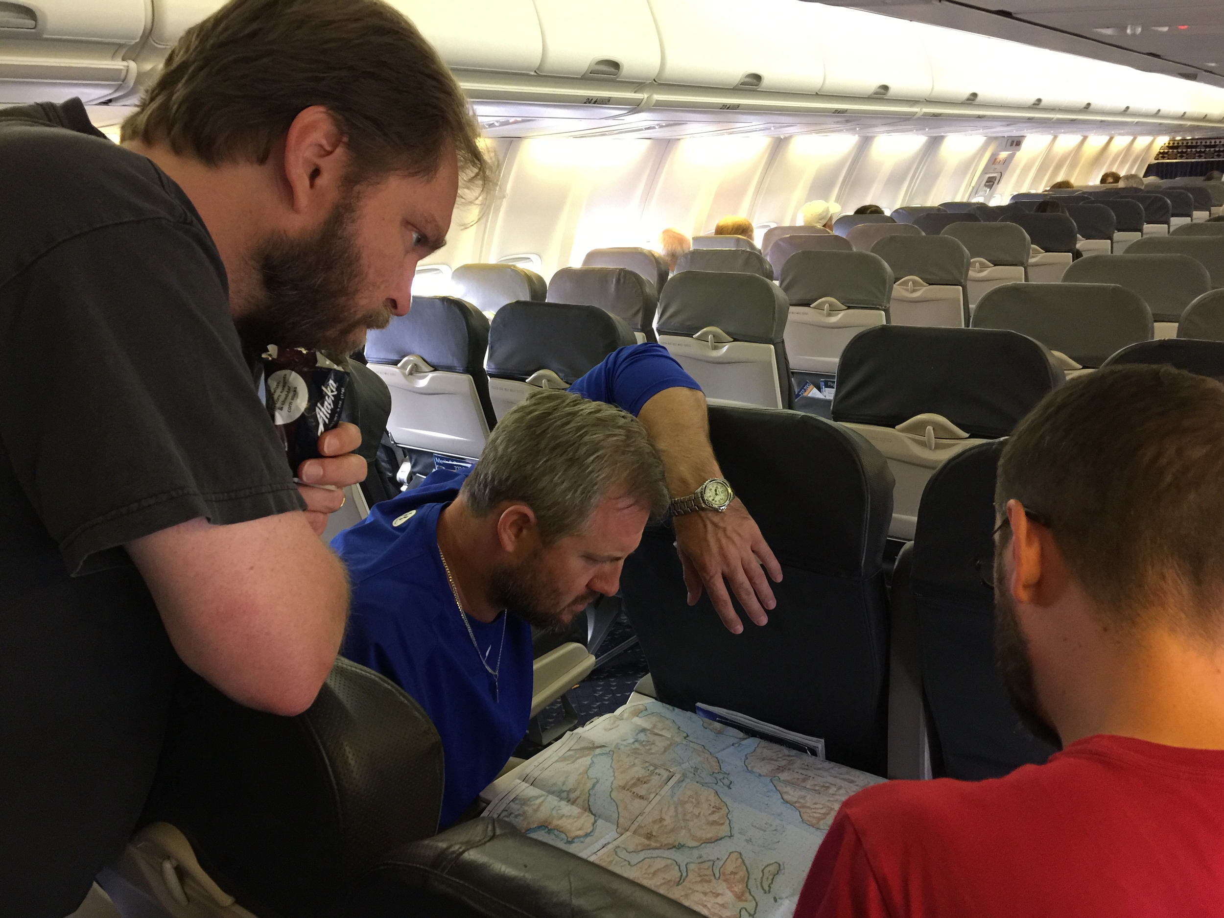An impromptu trip planning session due to a flat tire delay just prior to the final stretch from Juneau to Gustavus. Photo by D. Gehley