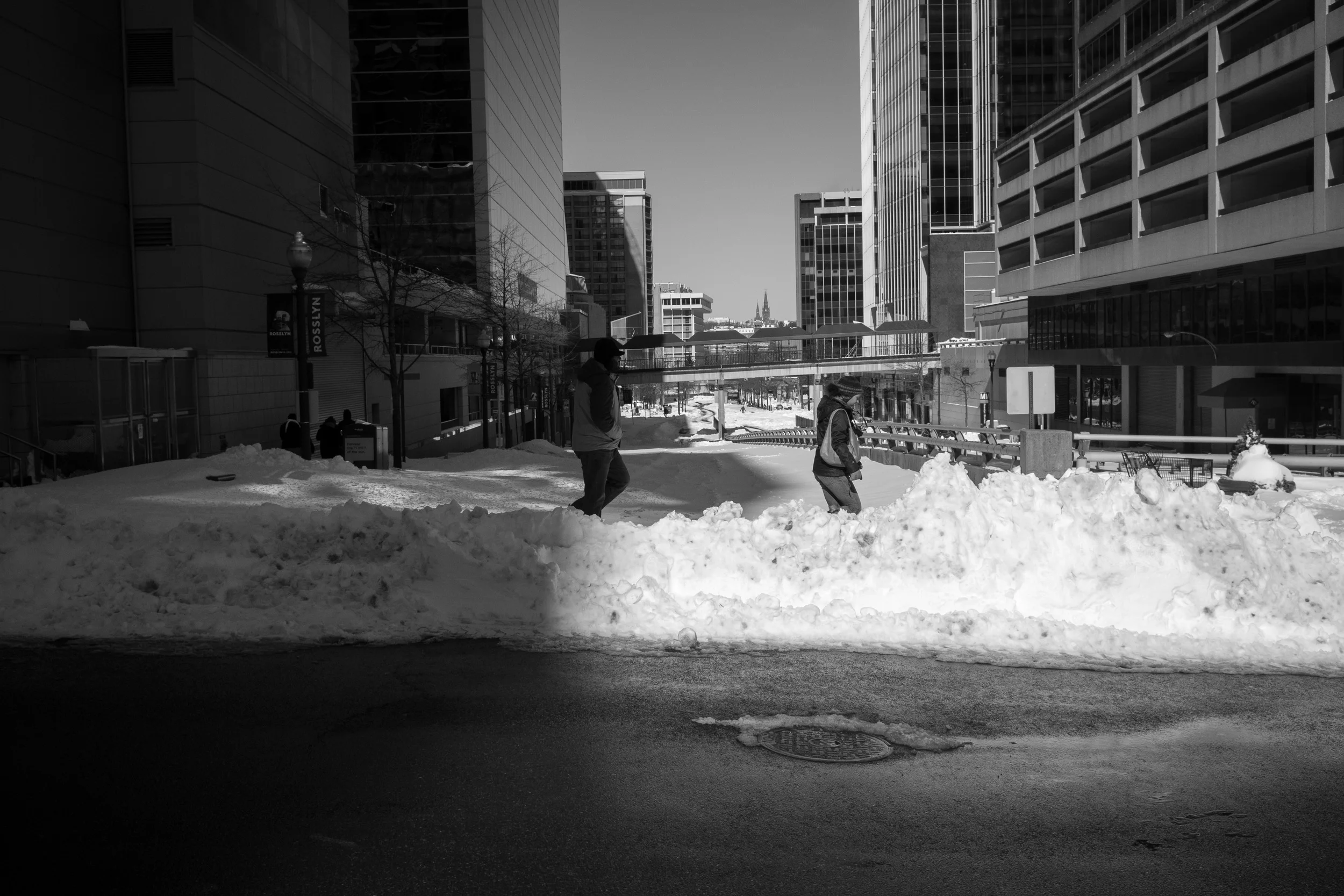 Even by noon, many side streets had not yet been plowed. I like the light in this photo, people emerging from the shadows; while some streets are cleared, many remain untouched and unexplored.
