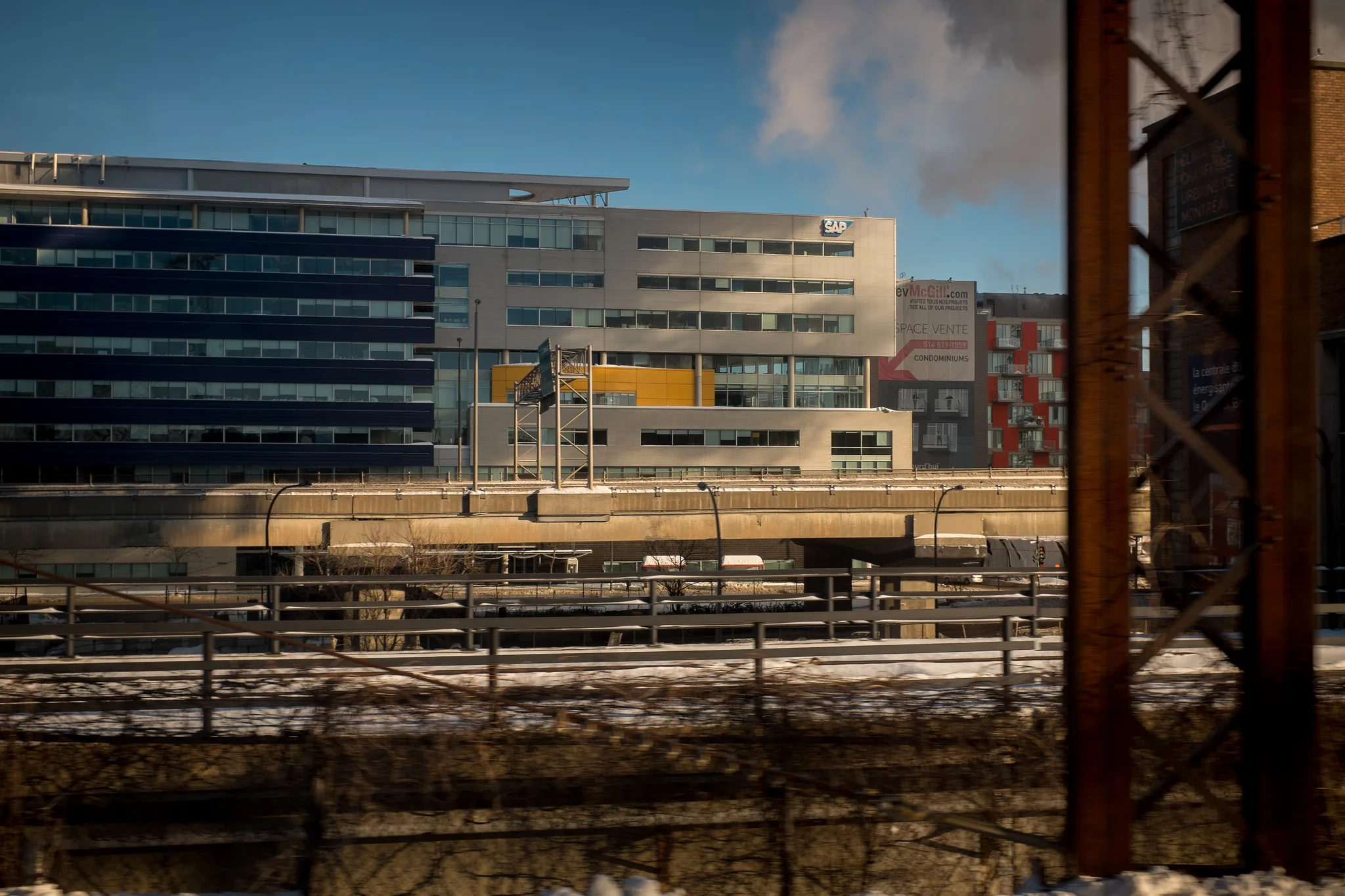 Photographing the backside of the city. The slightly burred train structure at the right adds just enough context to let the viewer know that this photo is taken from a train. I like the industrial look and hints of color in this image. It can be hard to frame a shot while the train is traveling at 60 m.p.h. so take plenty of shots. Fujifilm X100S, 1/160 @ f5.6, ISO 200.