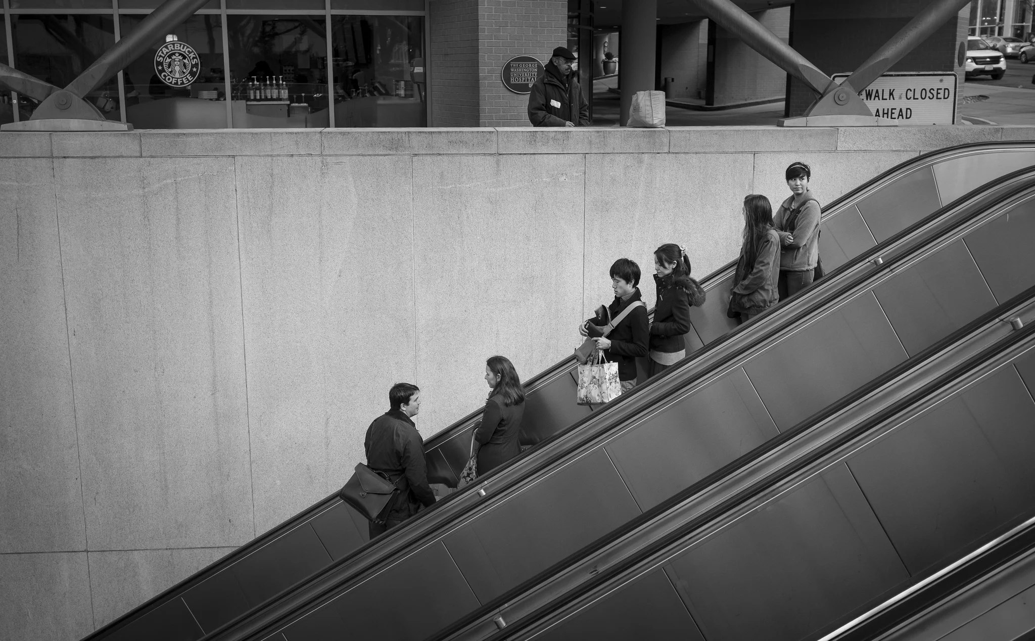 Think three-dimensionally. In this photograph of passengers entering the Foggy Bottom metro I used the rule of thirds to both place the subjects in upper right and the three diagonal lines of the escalators to draw you in to the frame. Fujifilm X100S, 1/250 @ f8, ISO 400.