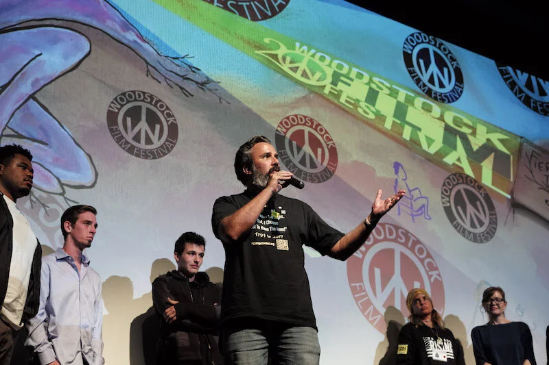 March for Our Lives founder Cameron Kasky (center left) with artist Manuel Oliver (center), Parkland Rising director Cheryl Horner McDonough (right) onstage at the screening