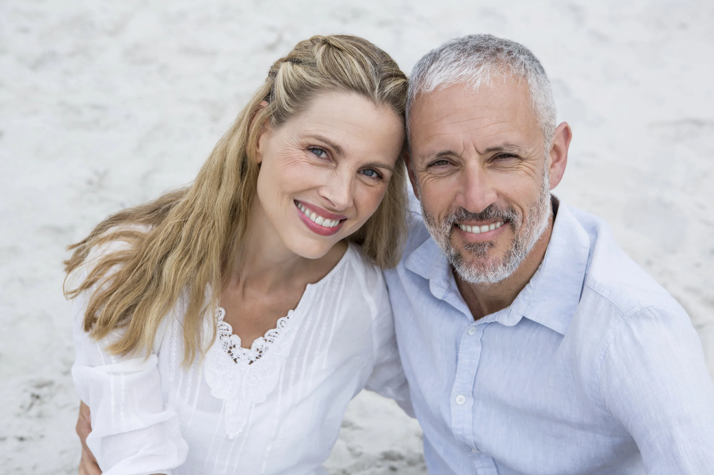 Middle age couple side hugging on the beach