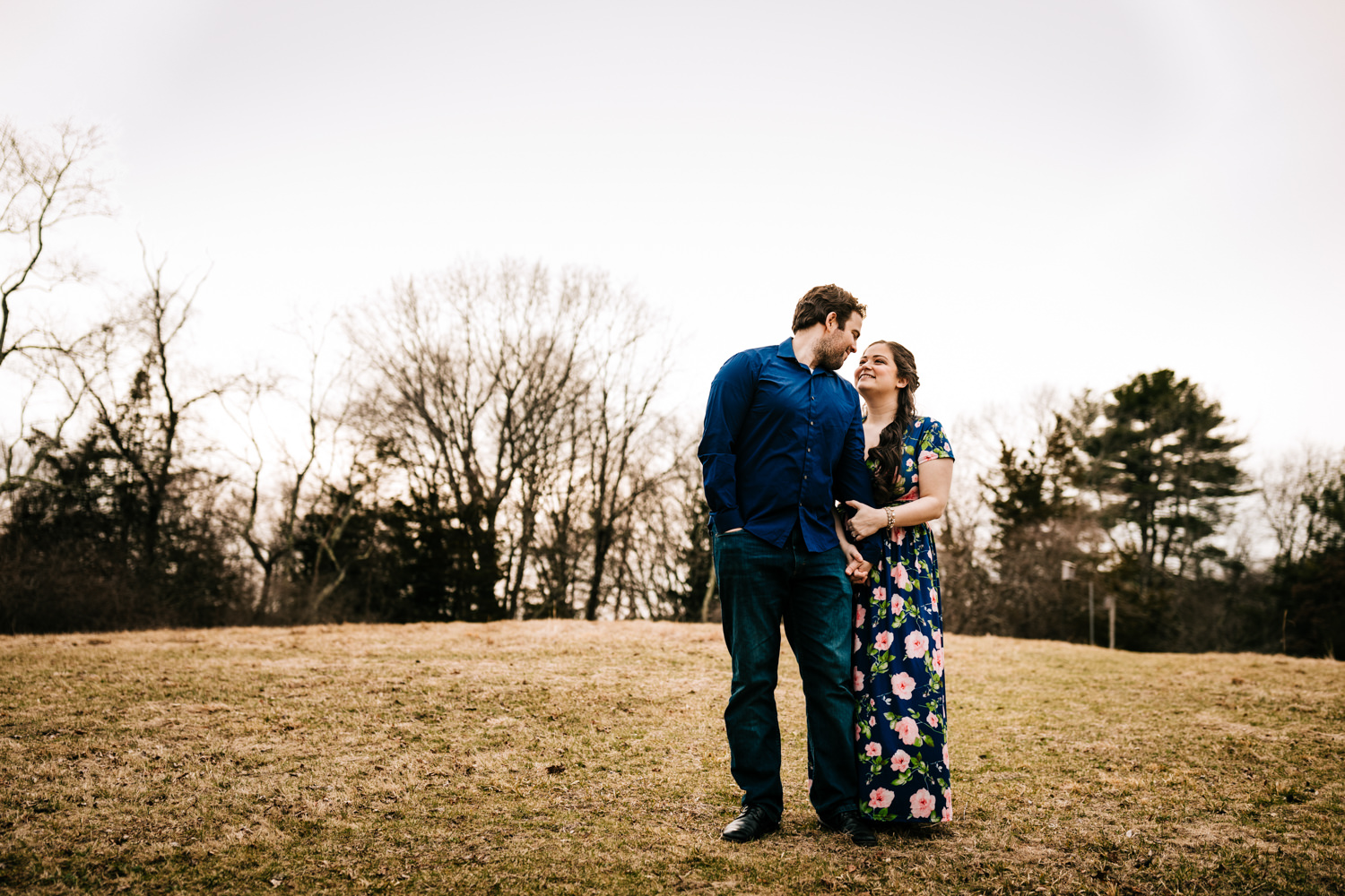 Couple walking through field in wildlife sanctuary in Massachusetts