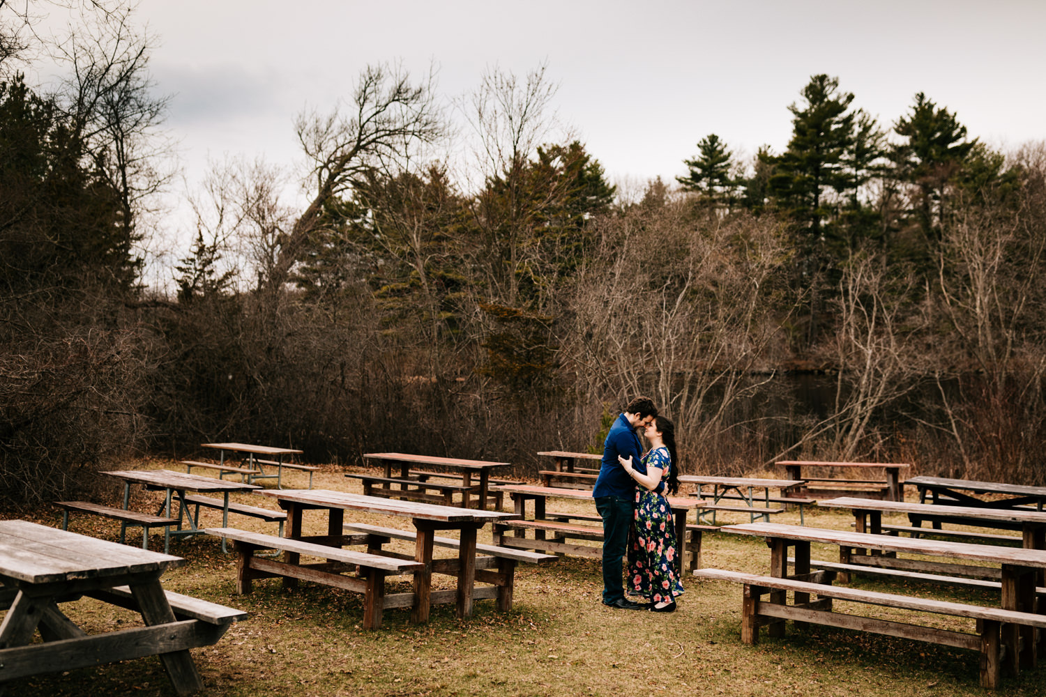 Couple around picnic tables on spring day wearing blue floral printed dress