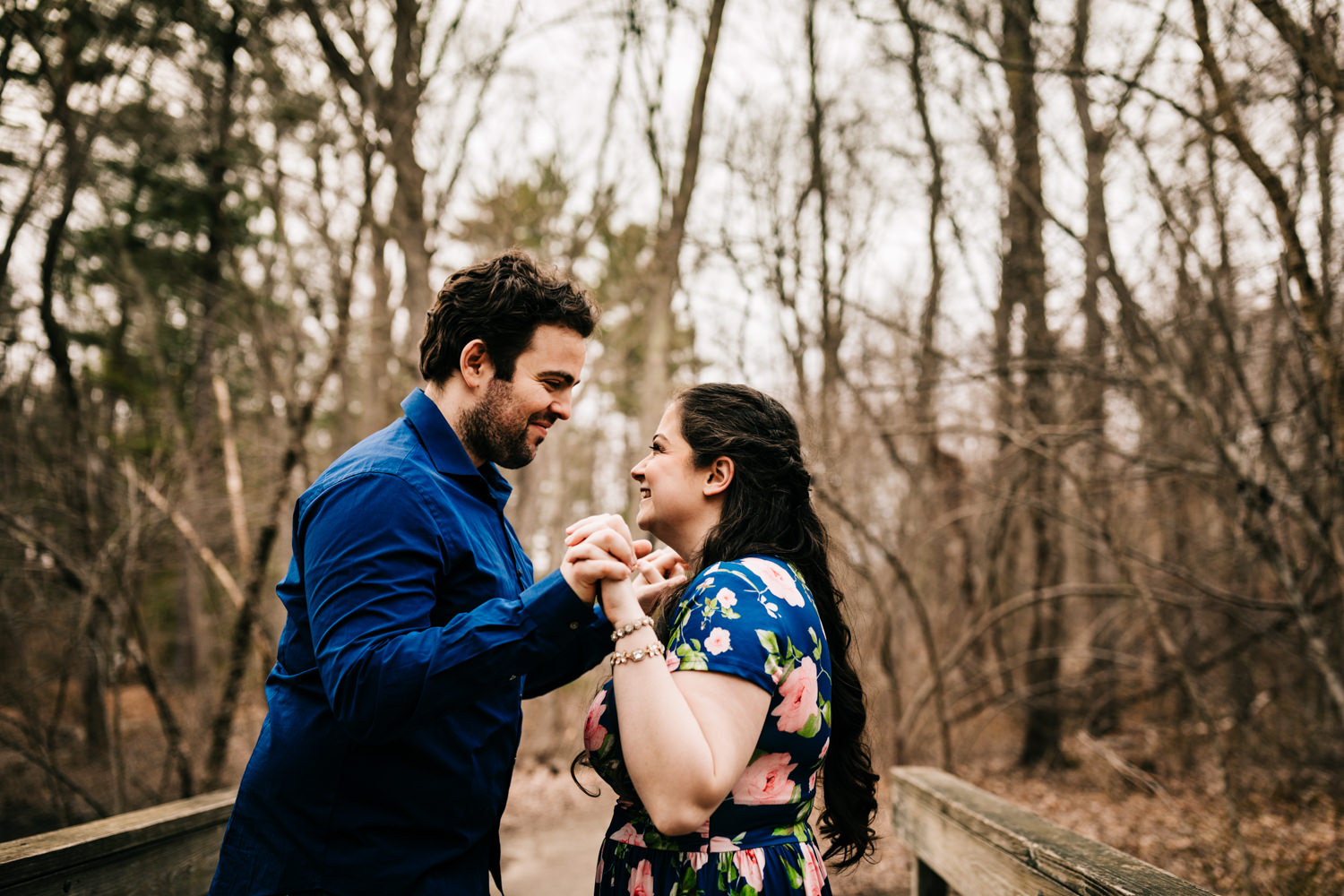 Fun couple playing in woods of Massachusetts