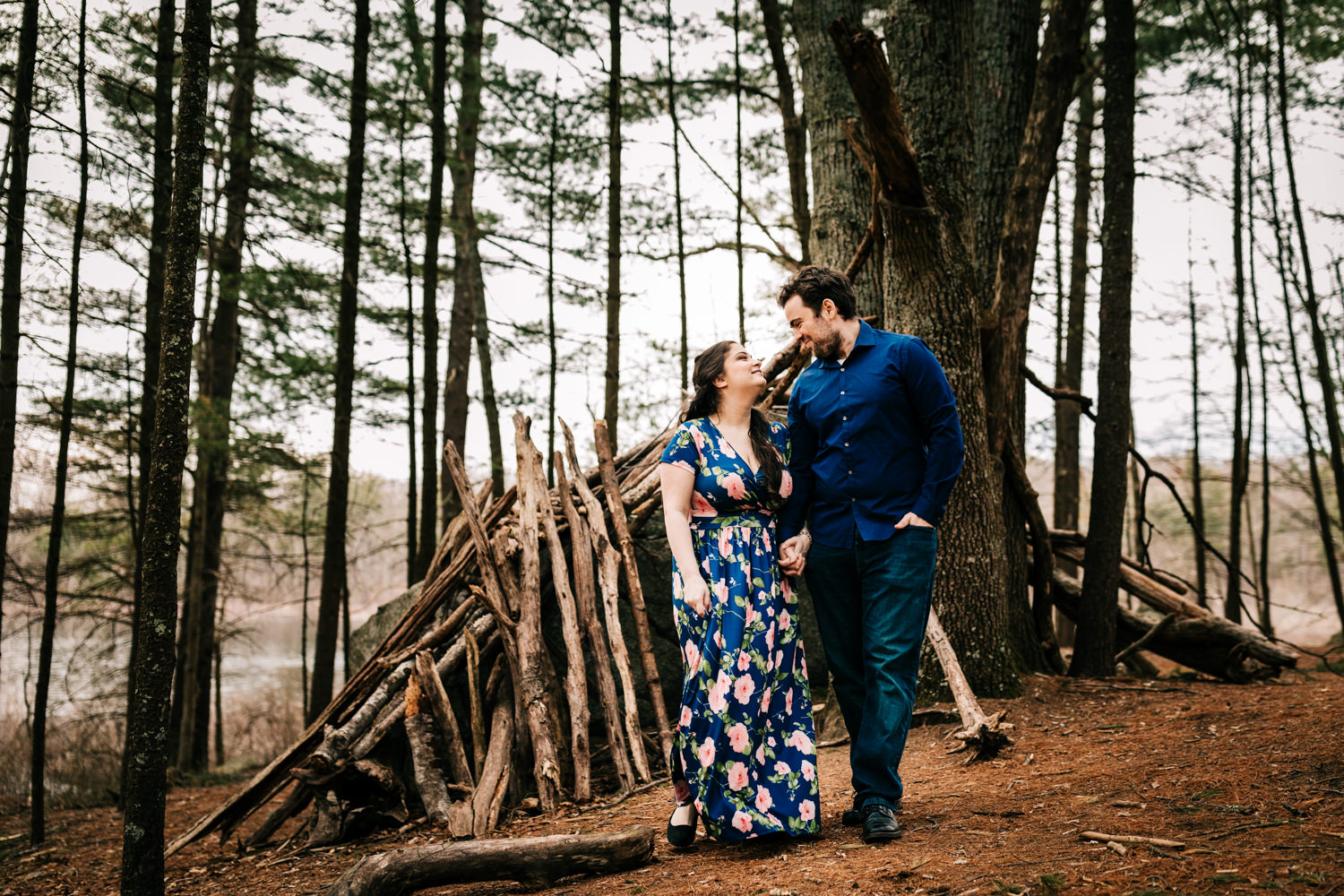 Couple wearing comfortable blue clothing at a forest shelter in a nature preserve in Boston