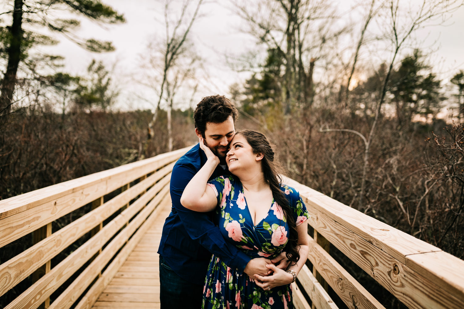 Couple hugging on boardwalk in Norwalk, Massachusetts