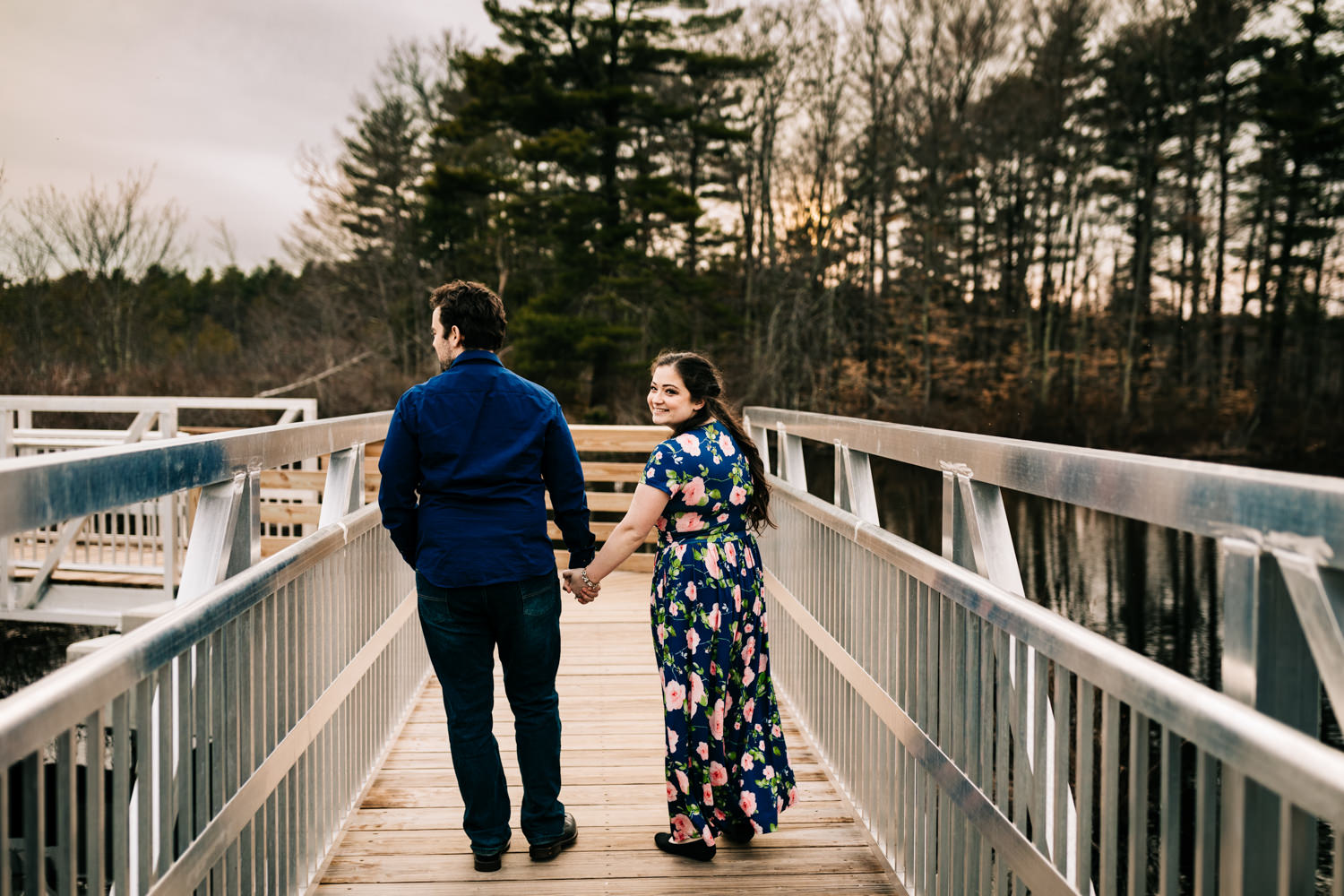 Couple walking down boardwalk in Massachusetts nature preserve