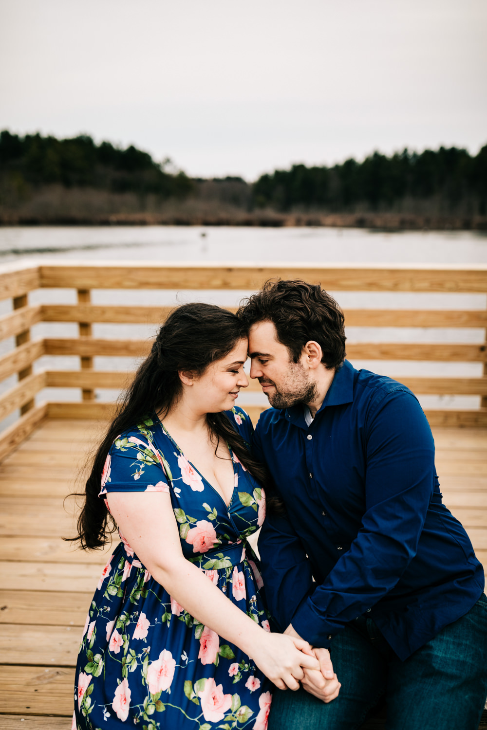 Couple on dock of lake inn blue floral maxi dress