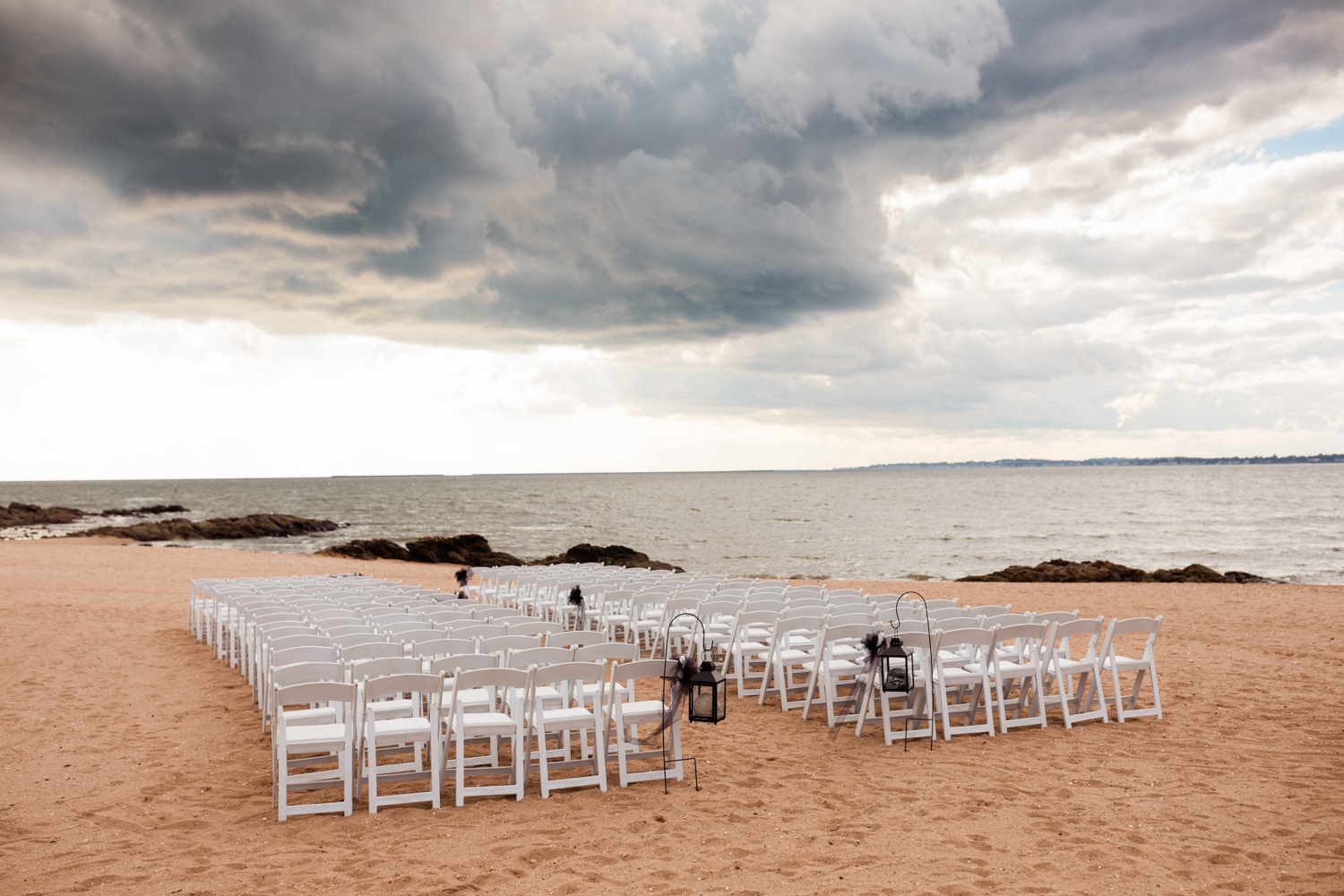 Beach wedding ceremony seating set up during storm