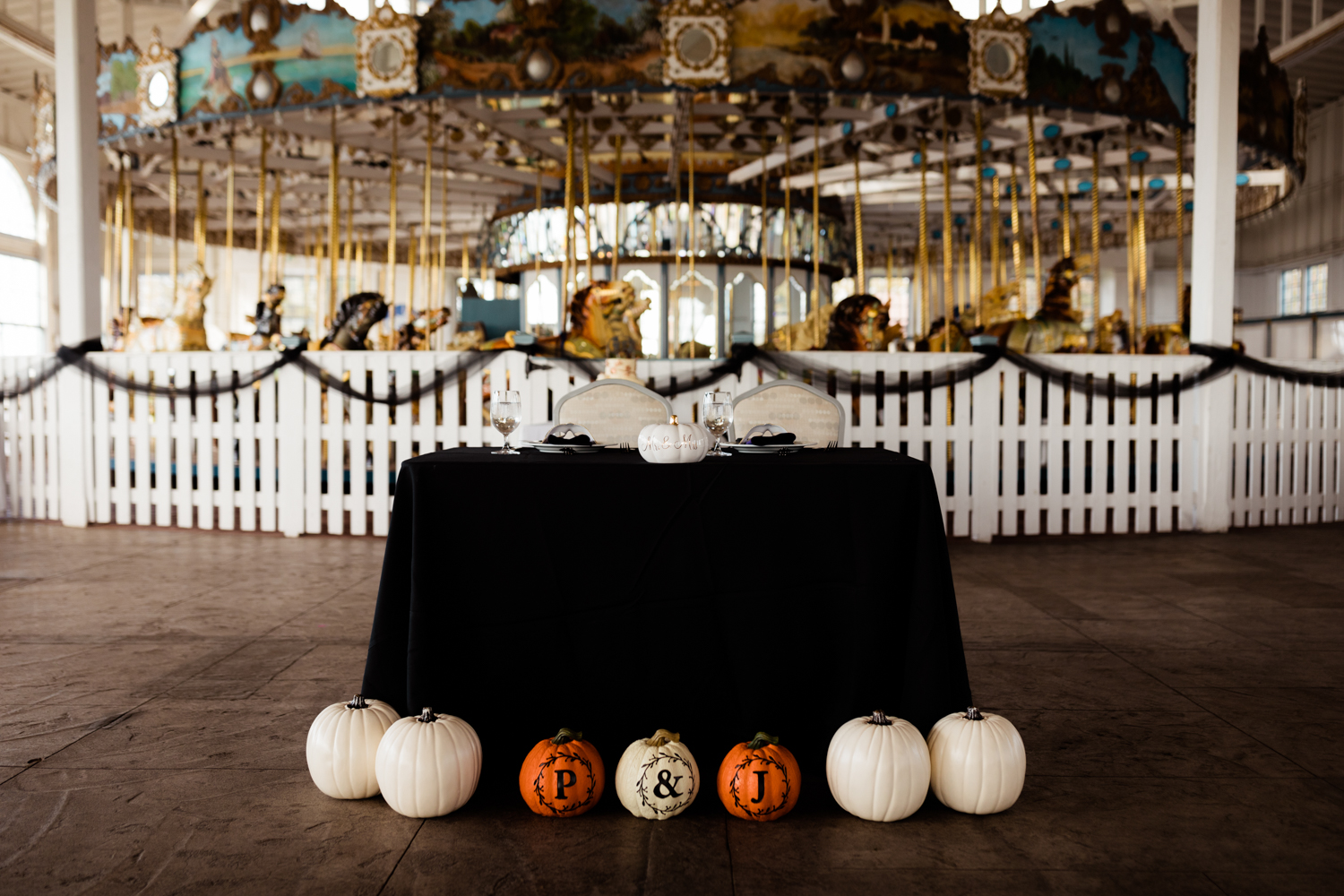 Halloween themed wedding sweetheart table with white pumpkins