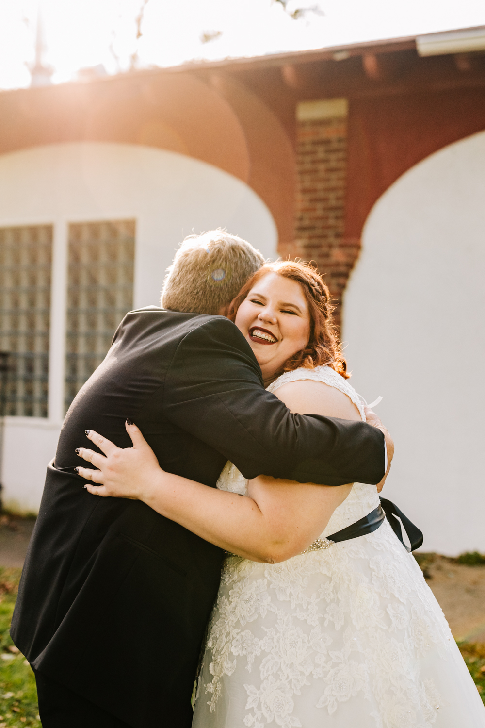 Bride hugging dad on wedding day