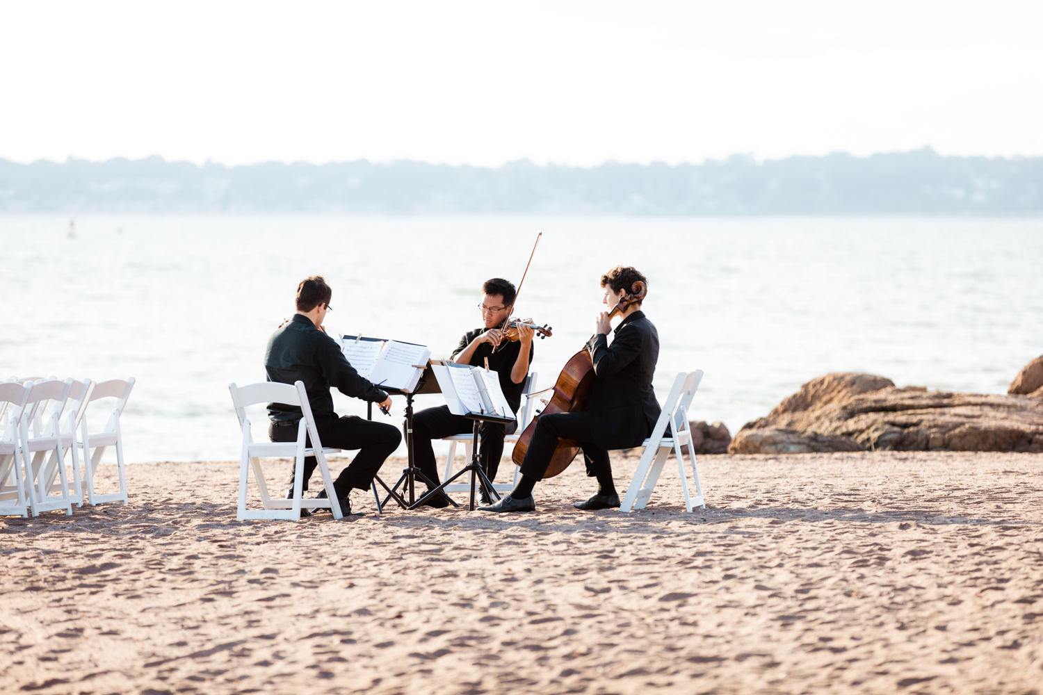 String band playing on the beach on wedding day