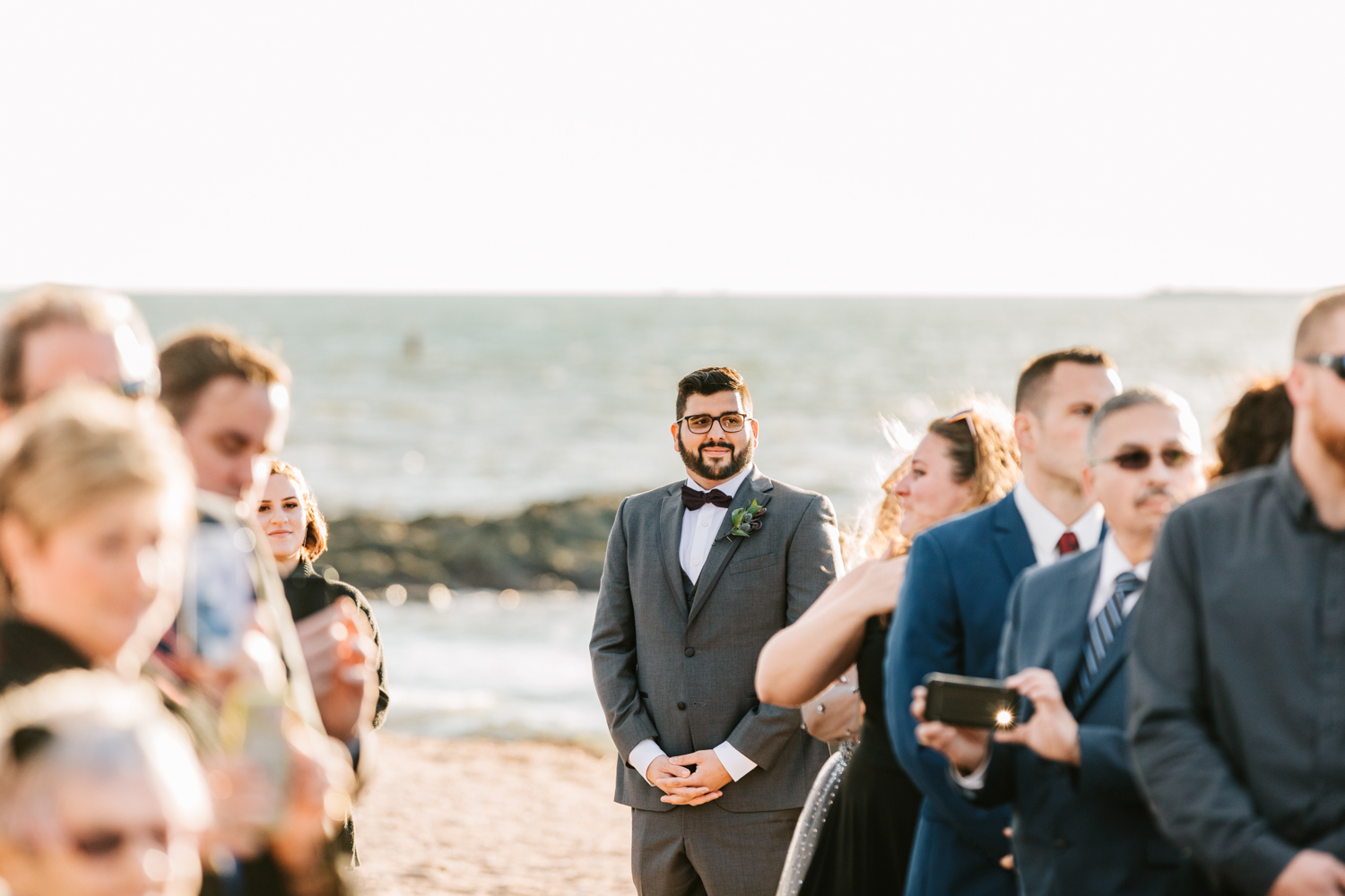 Groom seeing bride on wedding day during beach ceremony