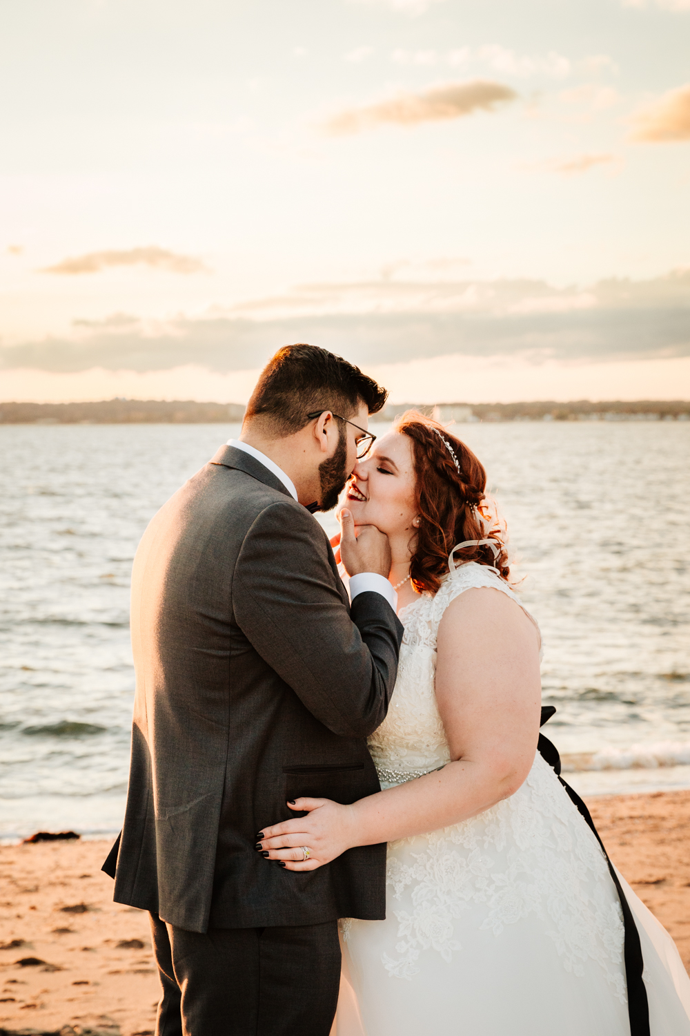 Bride and groom kiss on beach wedding