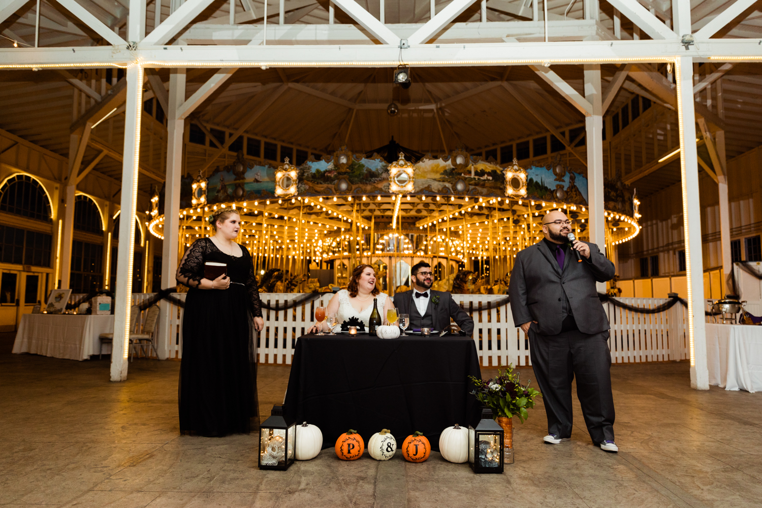 Wedding day speeches in front of carousel