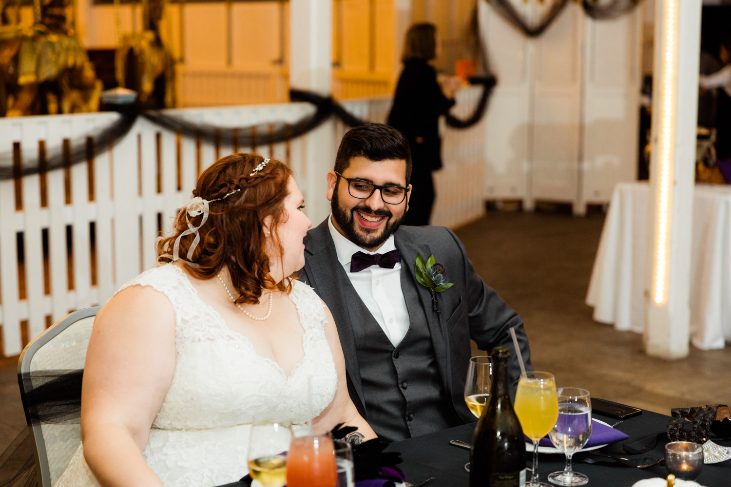 Bride and groom looking at eachother at carousel wedding