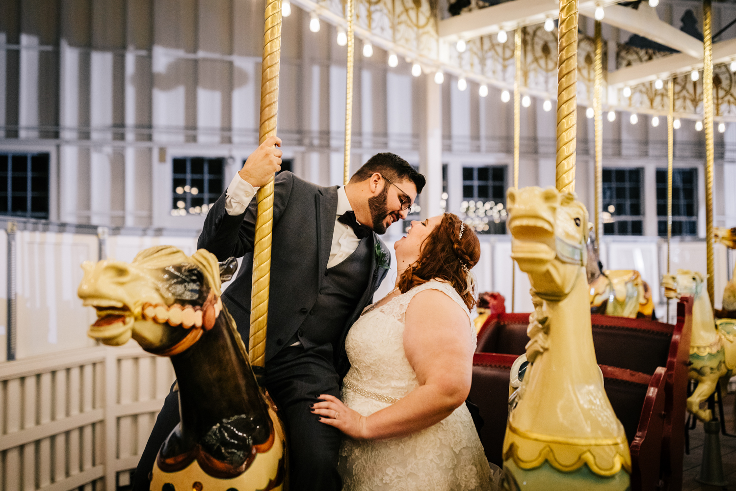 Wedding couple kissing on merry-go-round