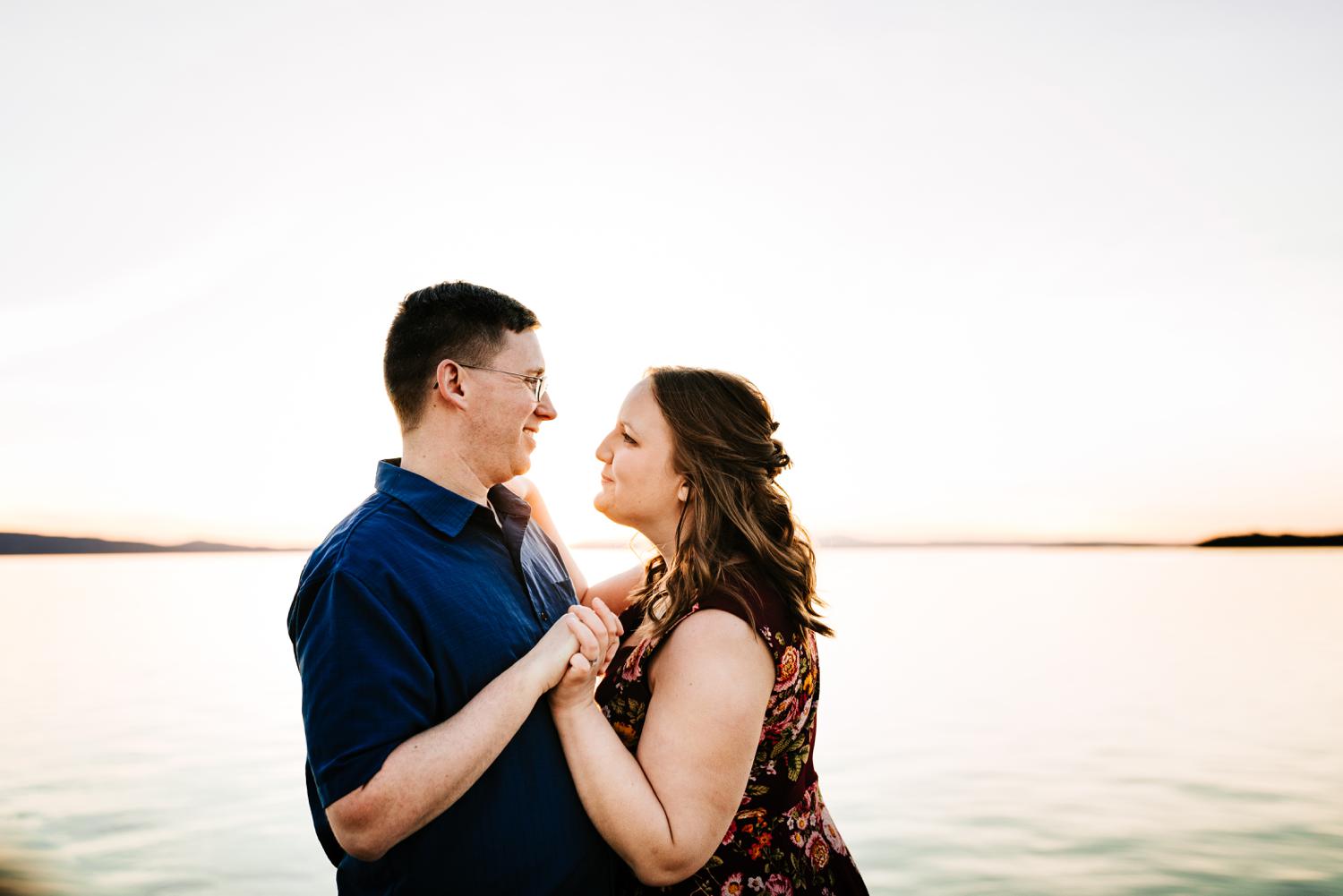 Couple dancing in mountain lake at sunset