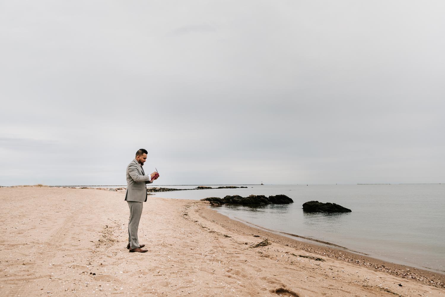 Groom waiting on beach for bride