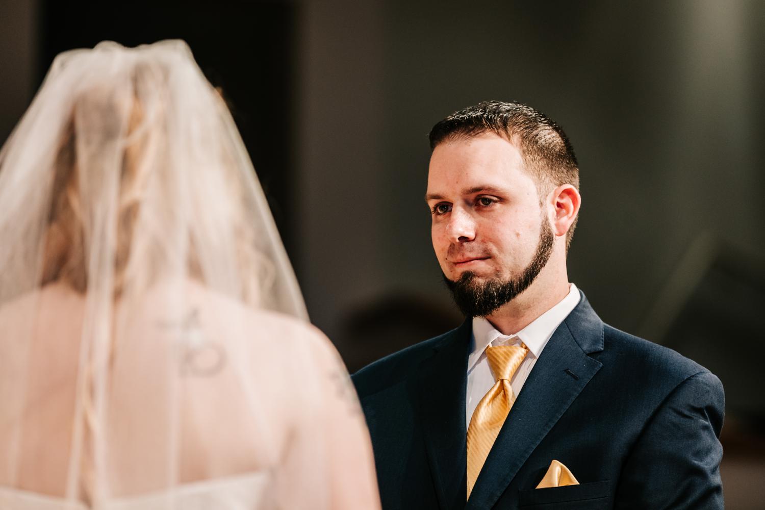 Groom's expression as he looks at bride