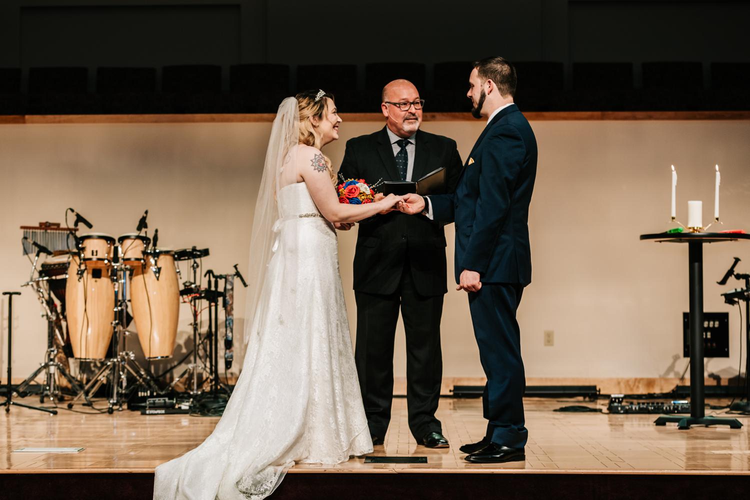 Bride and groom exchanging rings during wedding ceremony