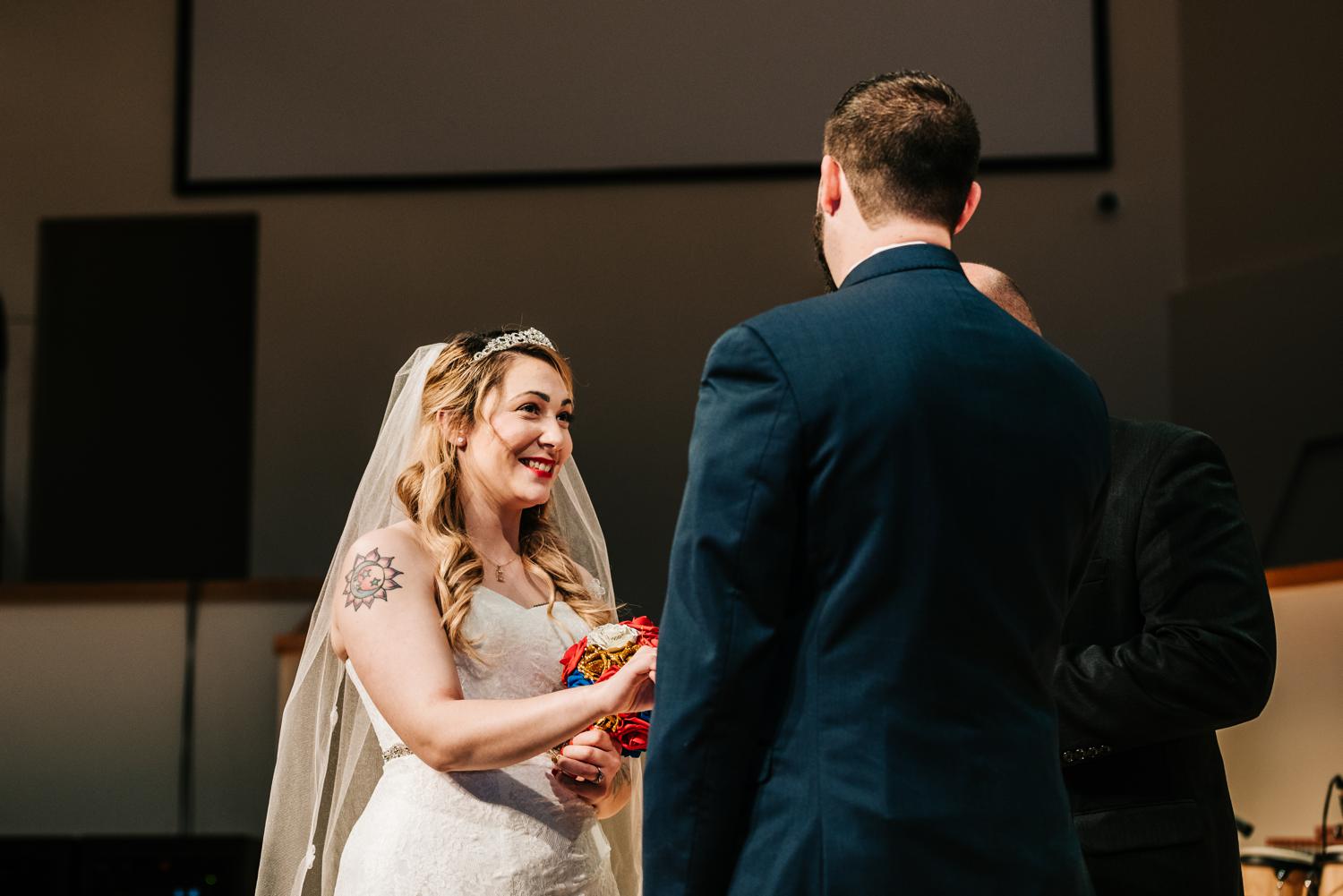 Bride smiling at groom during vows