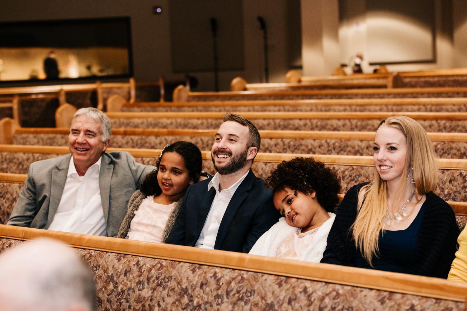 Wedding guests laughing at wedding ceremony