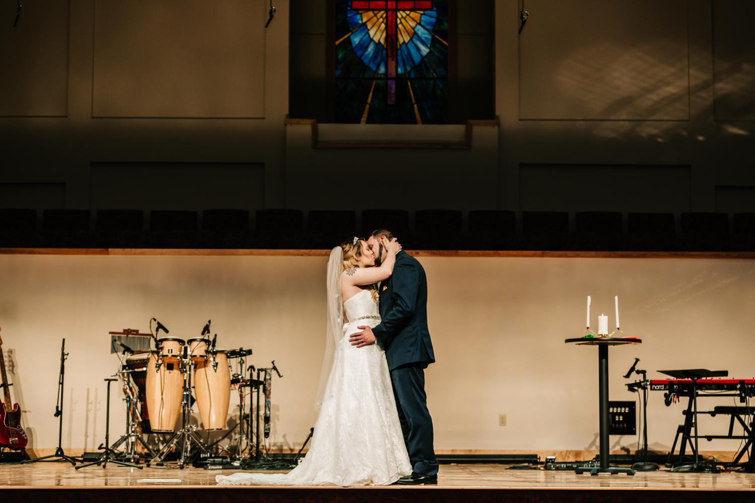 Tattoed bride' and groom's first kiss at altar