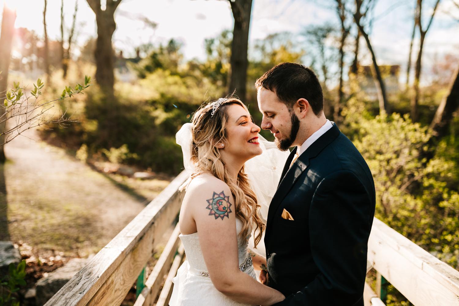 Bride and groom with tattoos before kissing