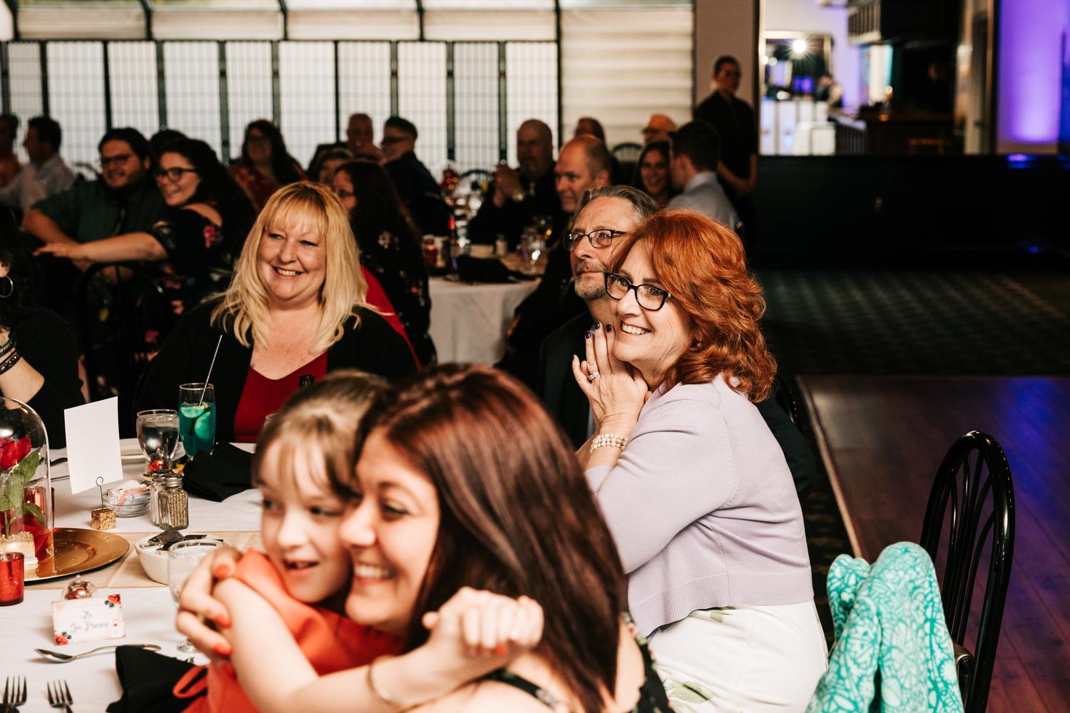 Guests happily watching bride and groom's first dance