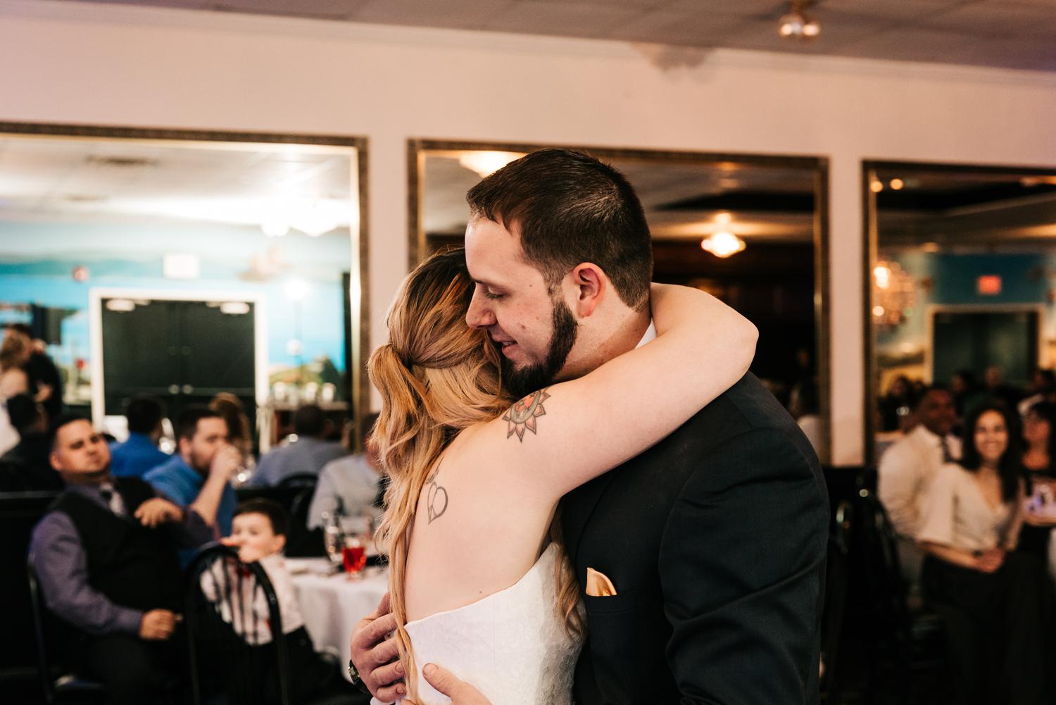 Bride and groom hugging during first dance