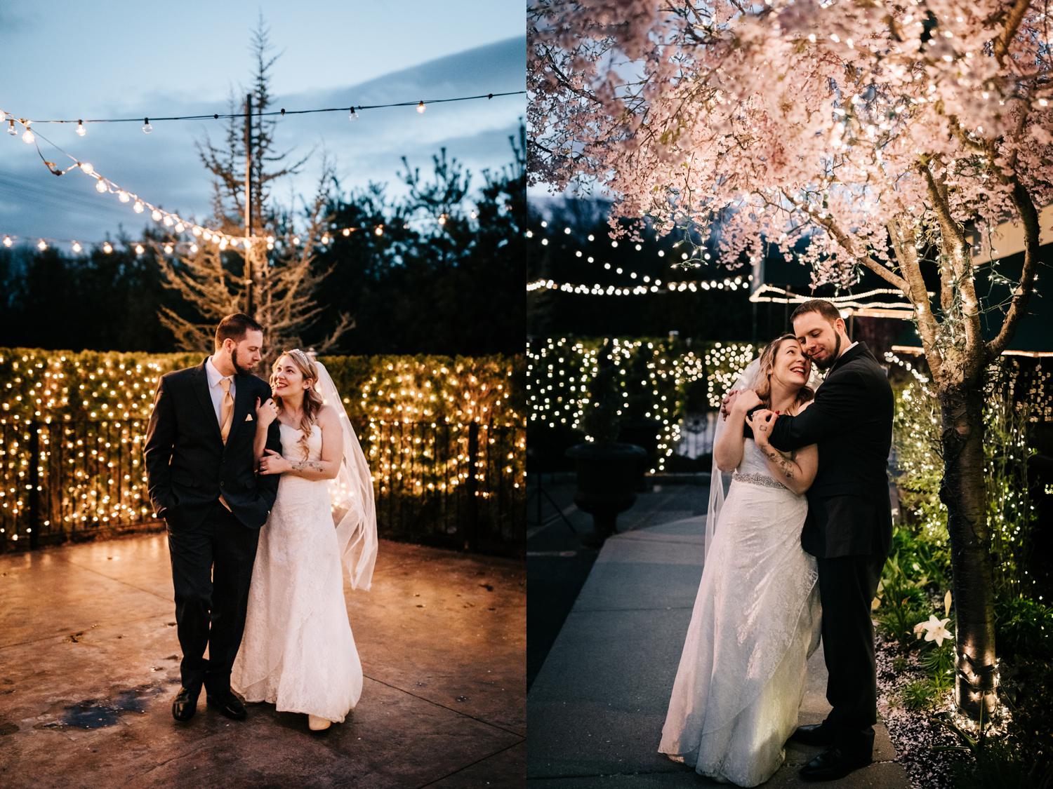 Bride and groom surrounded by twinkle lights outdoors at night