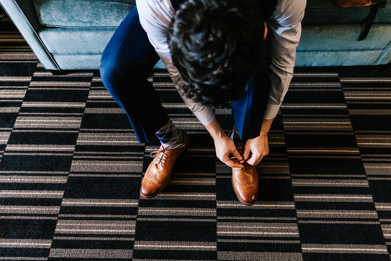 Groom Tying Shoes at El Paso Hotel