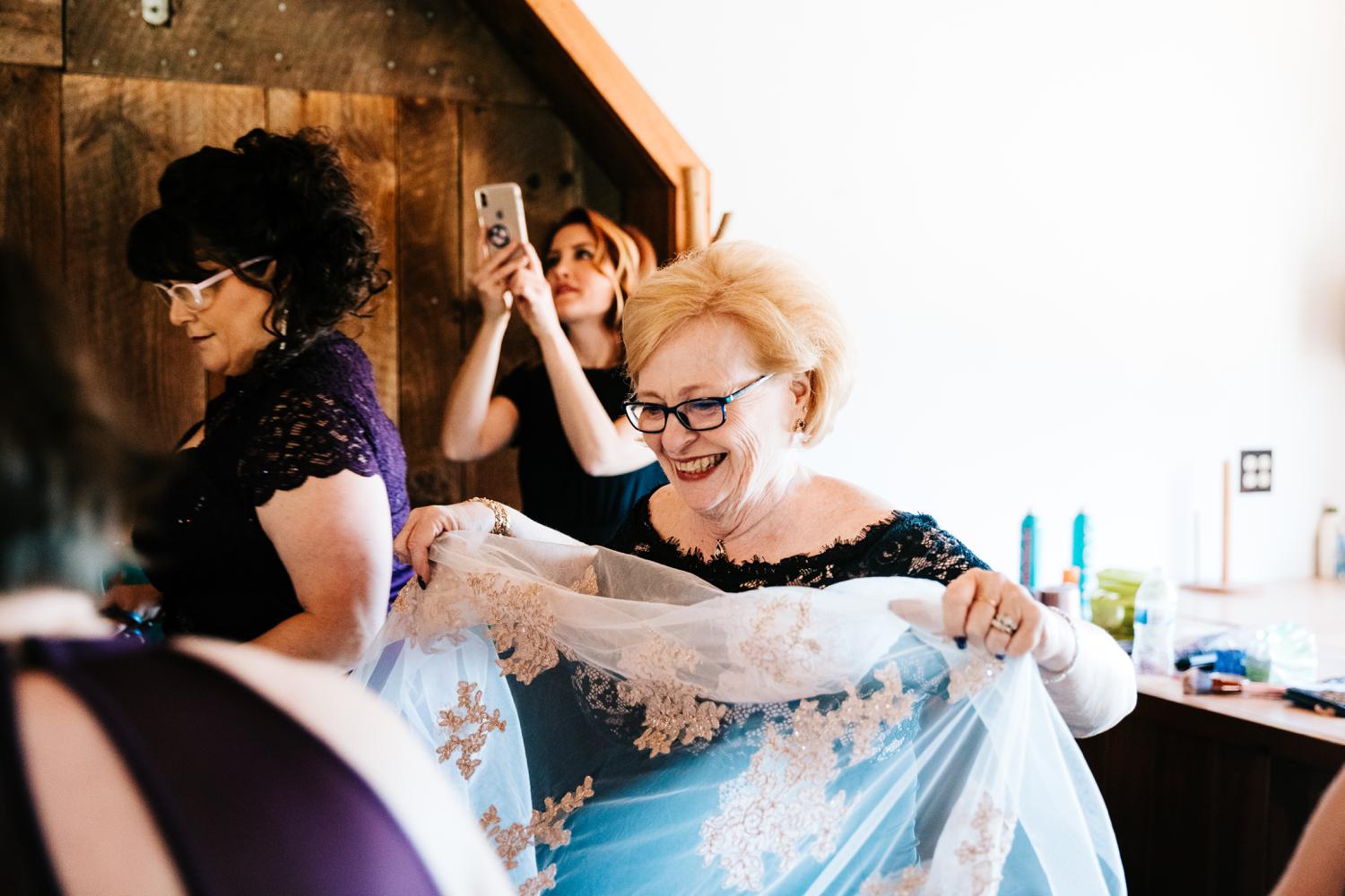 Bride's mother helping with wedding dress in El Paso