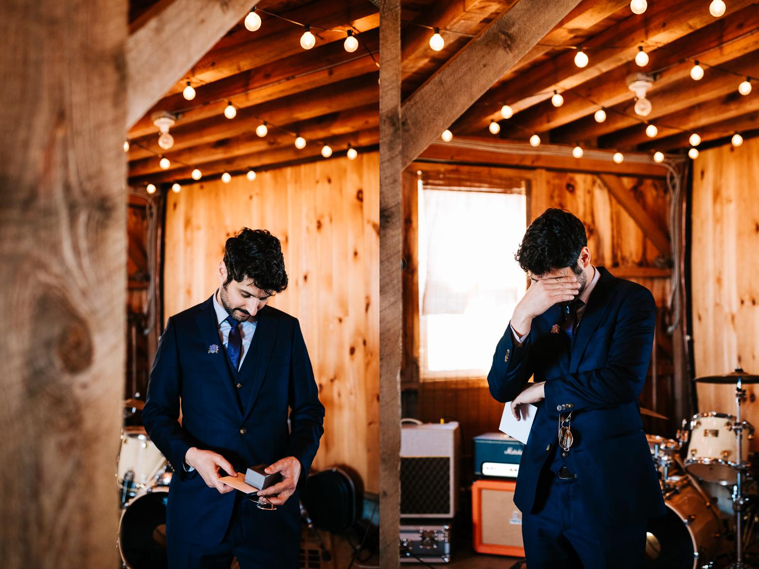 Groom reading note from bride in barn wedding in west Texas