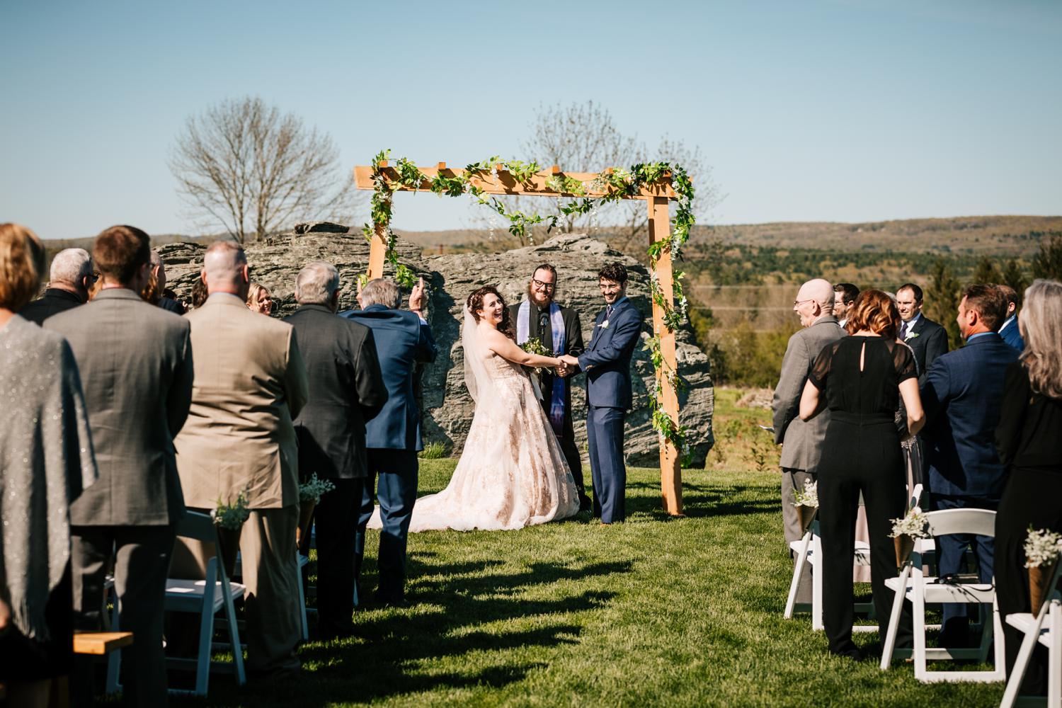 Bride and groom laughing during ceremony in Roswell