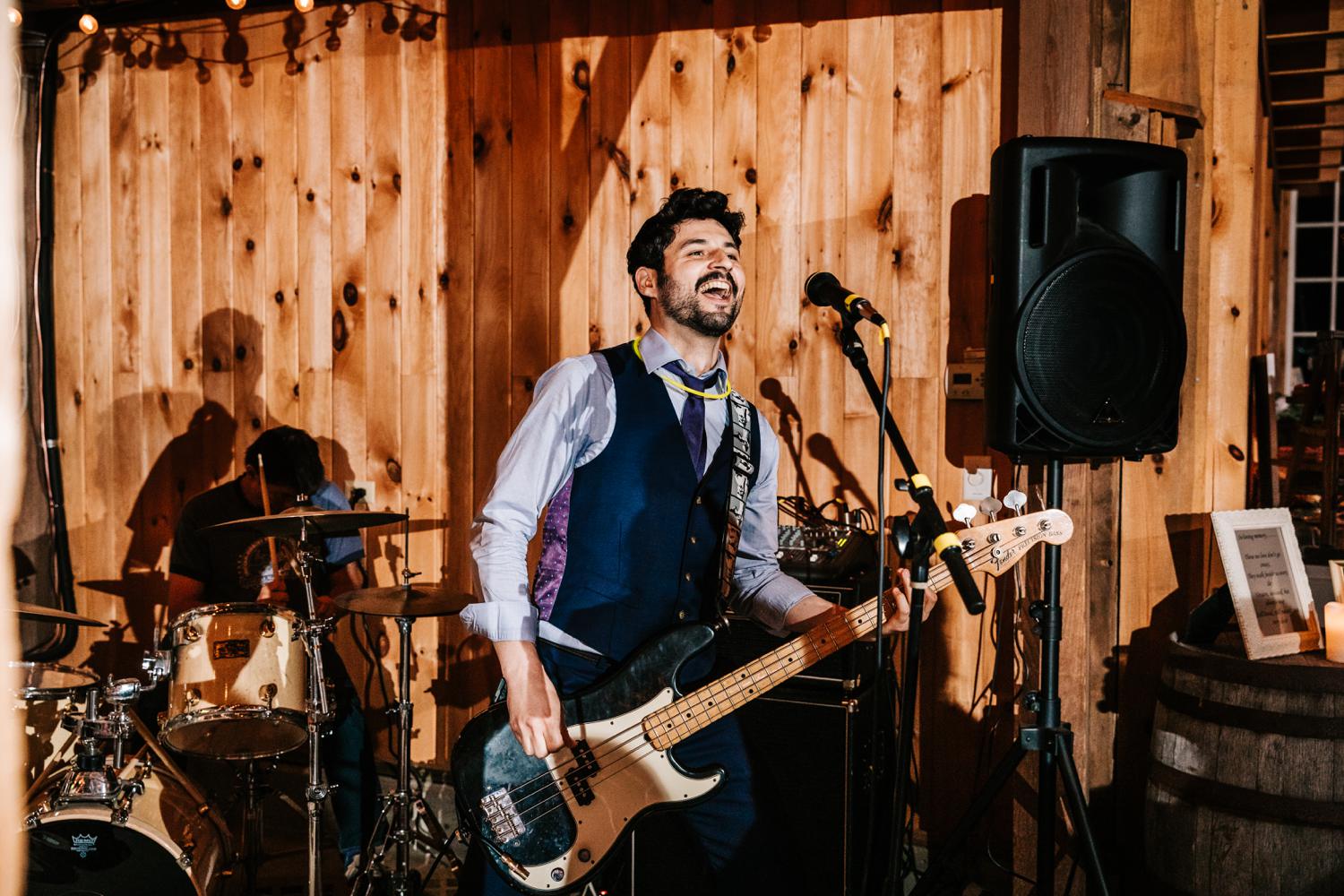 Groom playing guitar at music themed Albuquerque wedding reception