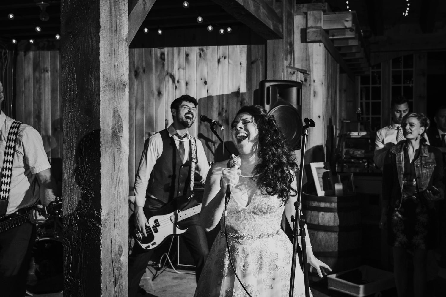 Bride and groom singing while band plays during El Paso wedding reception