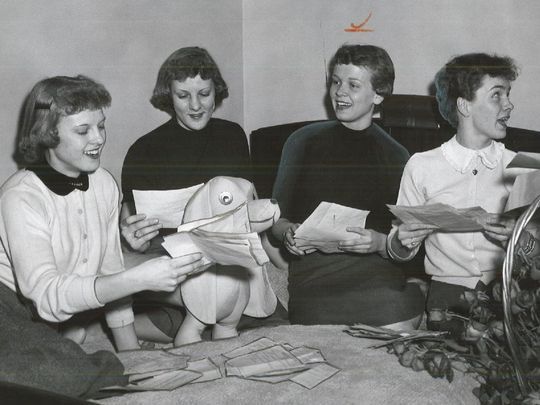In this 1956 Register file photo, Carolyn Nicholson (far left) is reading a congratulatory telegram after the Maynard High School girls' basketball team won a state championship. A movie about Maynard's state title-winning season and Nicholson's life is being made. ( Photo: Register file photo )